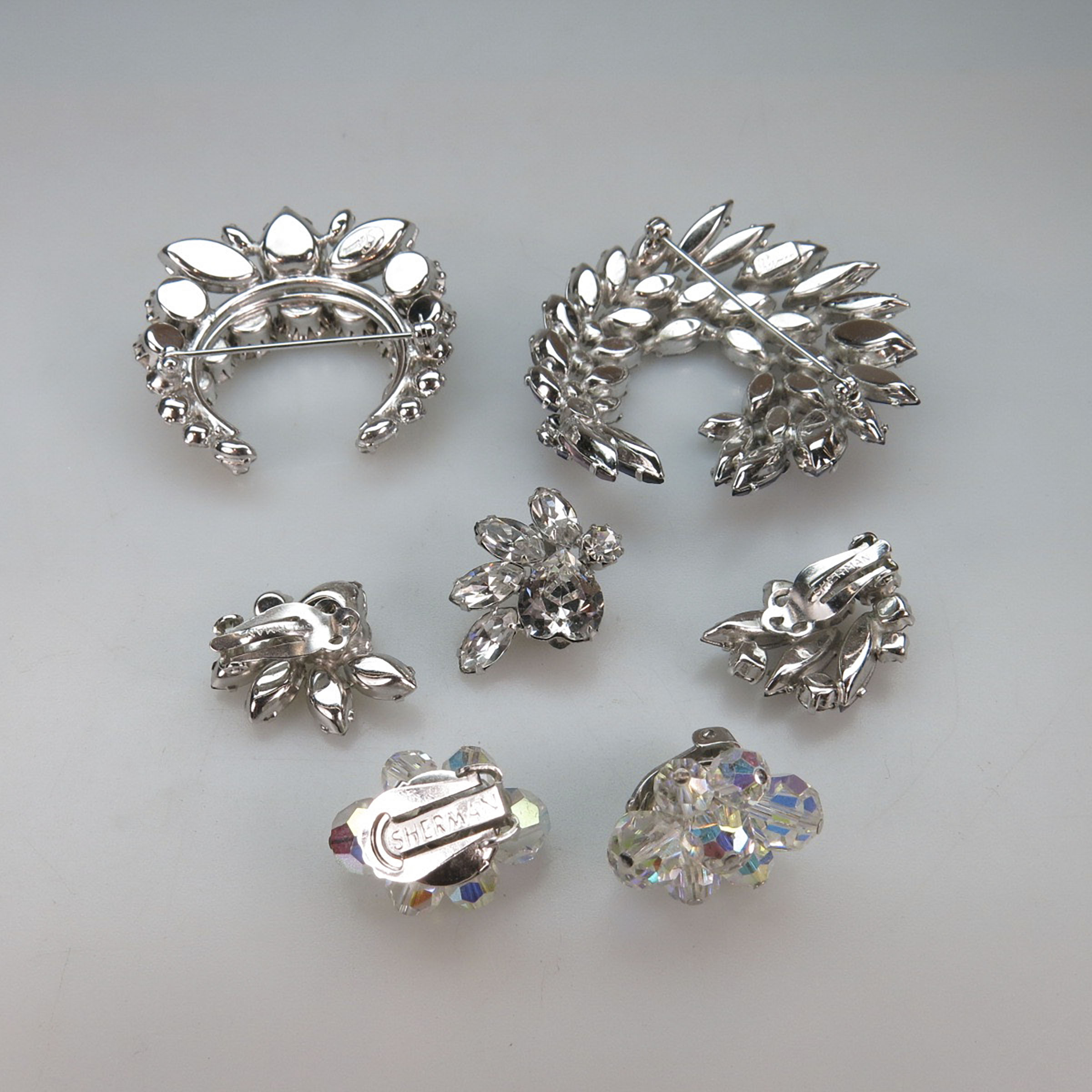 Two Sherman Silver Tone Metal Brooches, Two Pairs Of Clip-Back Earrings, & A Single Earring