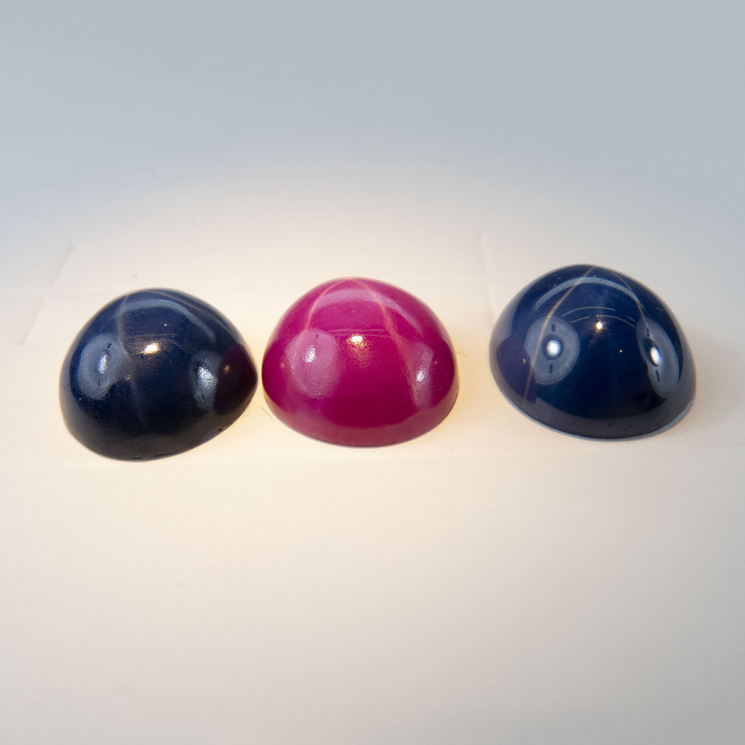 Synthetic Oval Star Ruby And 2 Synthetic Oval Star Sapphire Cabochons