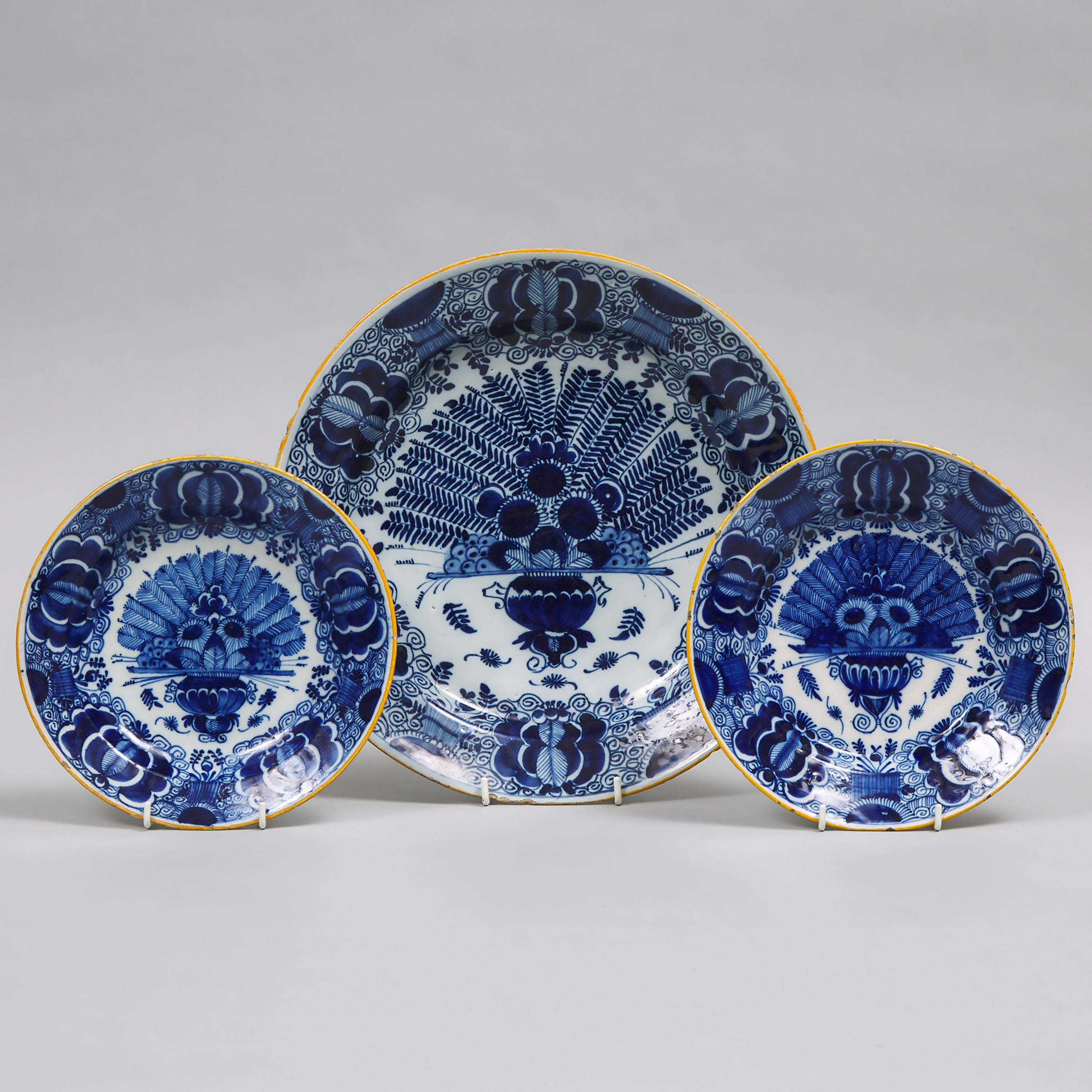 De Porceleyne Klaauw Delft Blue Painted 'Peacock' Pattern Charger and a Pair of Plates, 18th century