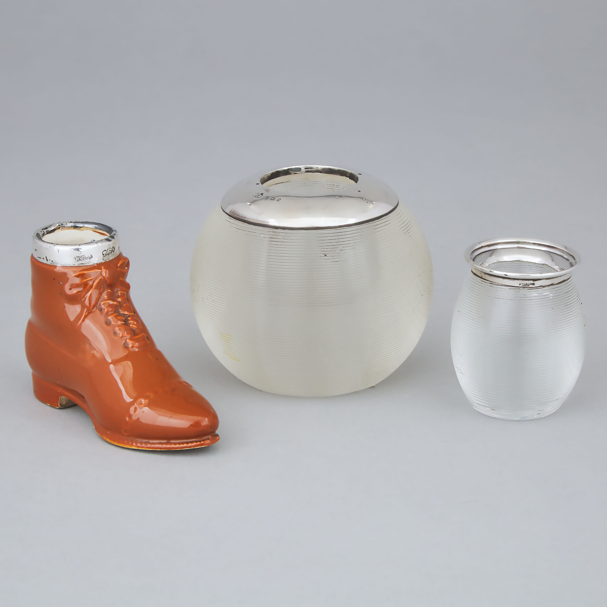 Two Silver Mounted Threaded Glass Match Strikers and a Porcelain Boot, early 20th century