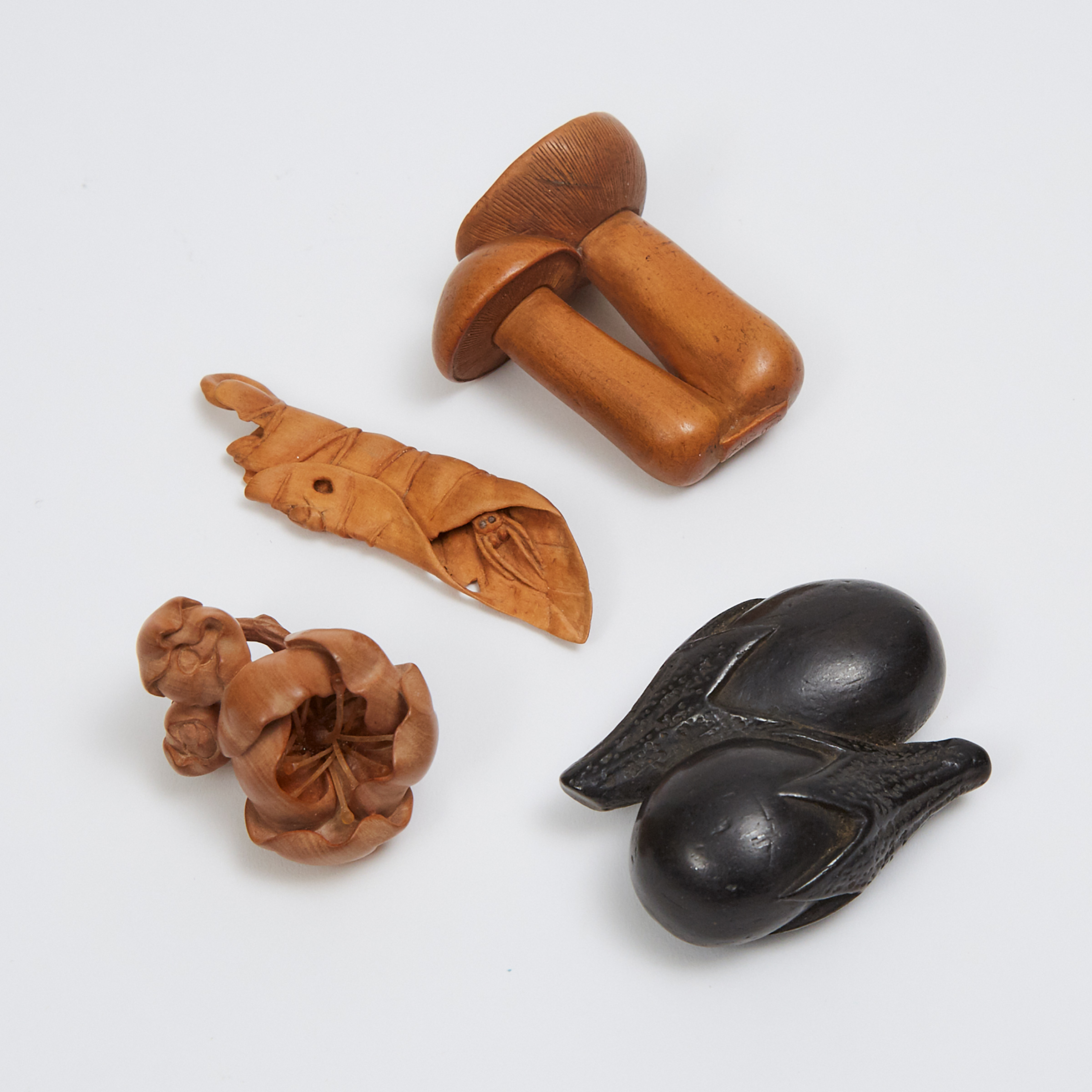 A Group of Four Boxwood and Ebony Netsuke of Vegetables, Cherry Blossoms, and a Leaf, Three Signed, 19th/20th Century