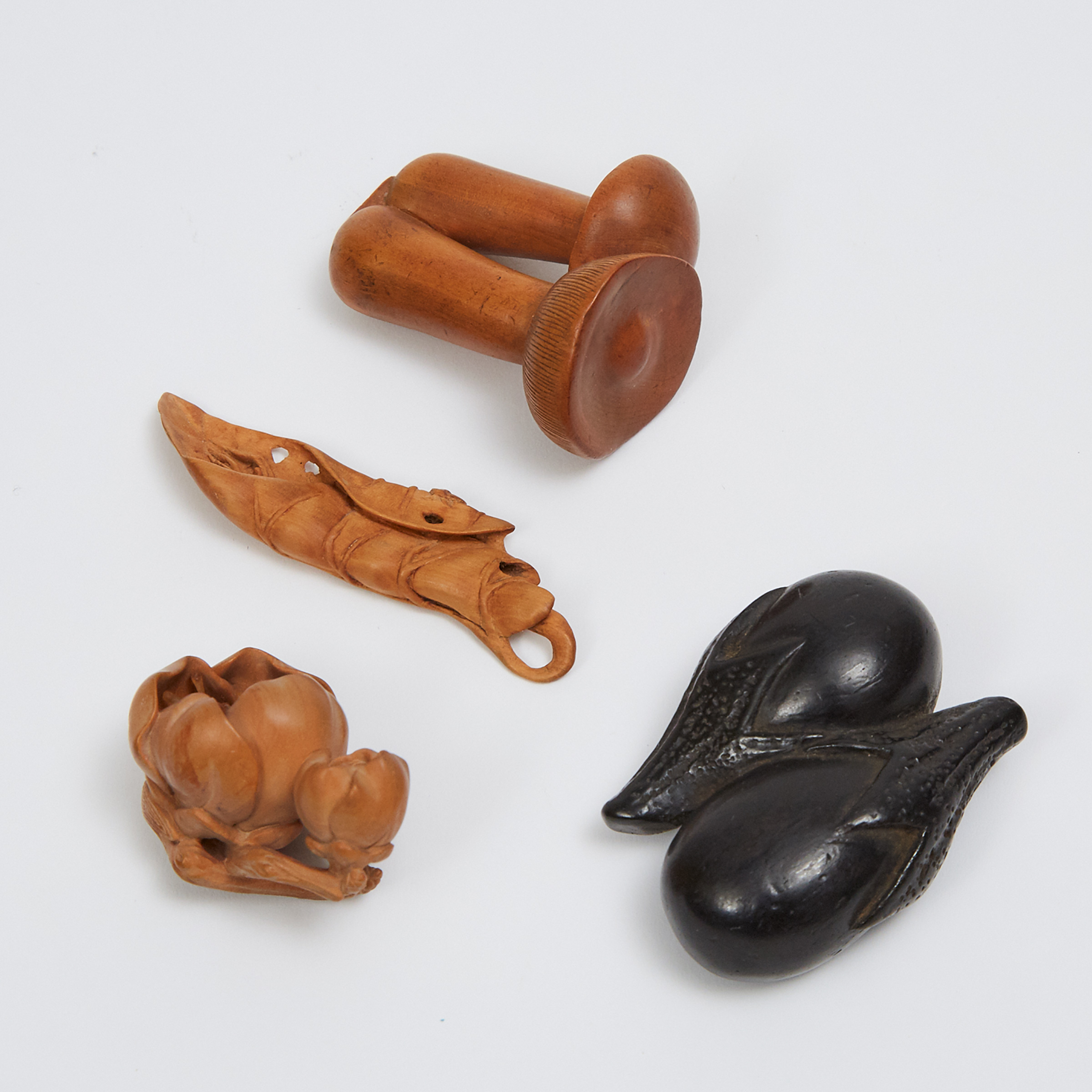 A Group of Four Boxwood and Ebony Netsuke of Vegetables, Cherry Blossoms, and a Leaf, Three Signed, 19th/20th Century