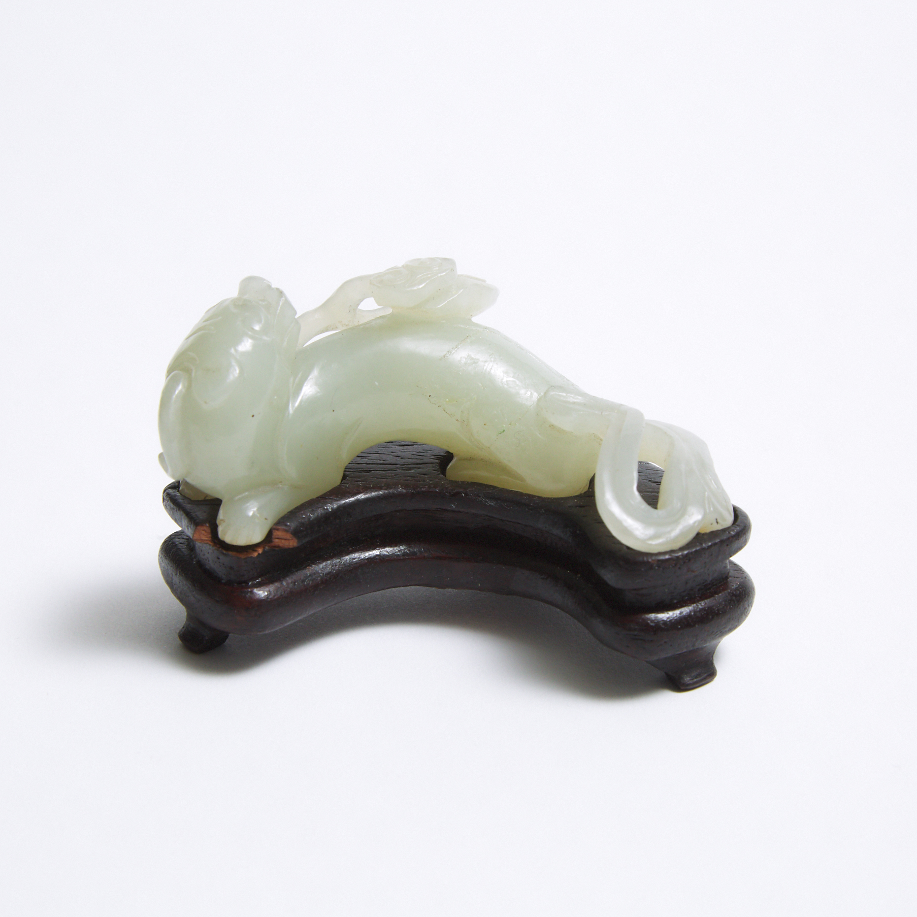 A Pale Celadon Carving of a Mythical Beast with Lingzhi, Qing Dynasty