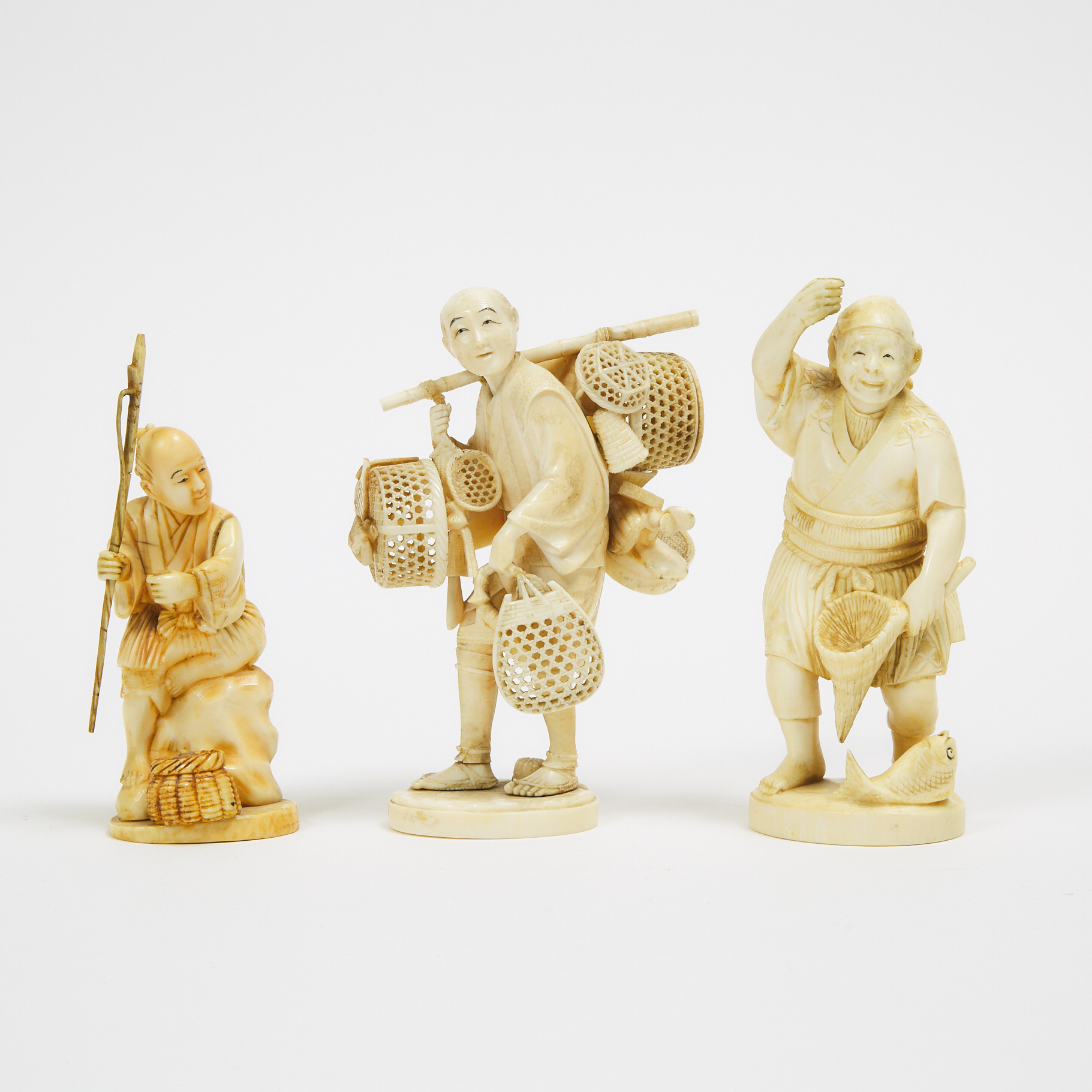 A Group of Three Ivory Okimono of Fishermen and a Merchant, Meiji Period