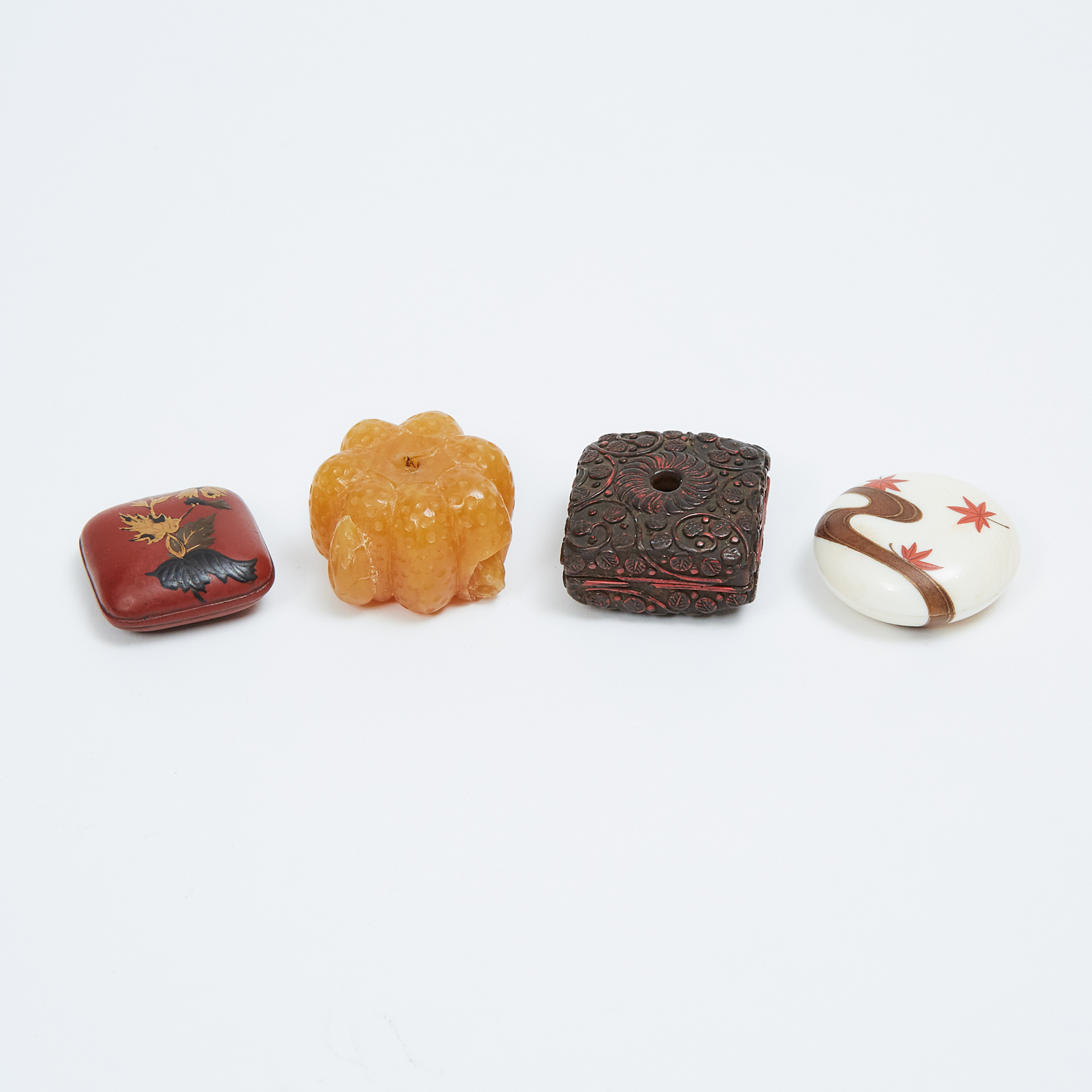 A Group of Four Ivory, Amber, and Lacquer Carved Manju Netsuke, Three Signed