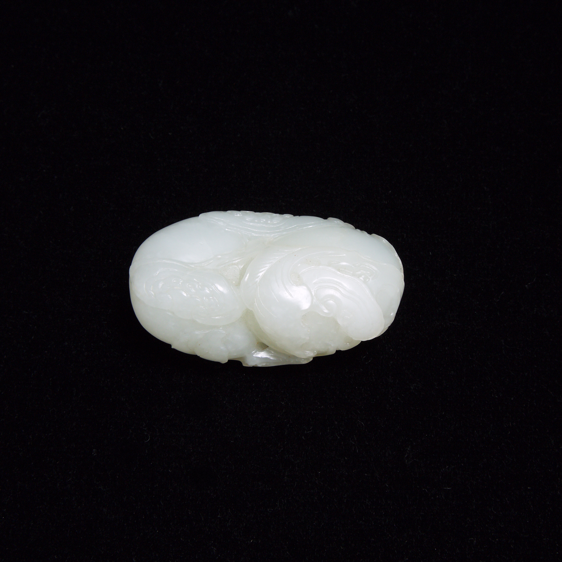 A Mottled White Jade 'Ruyi and Persimmon' Carving, Qing Dynasty