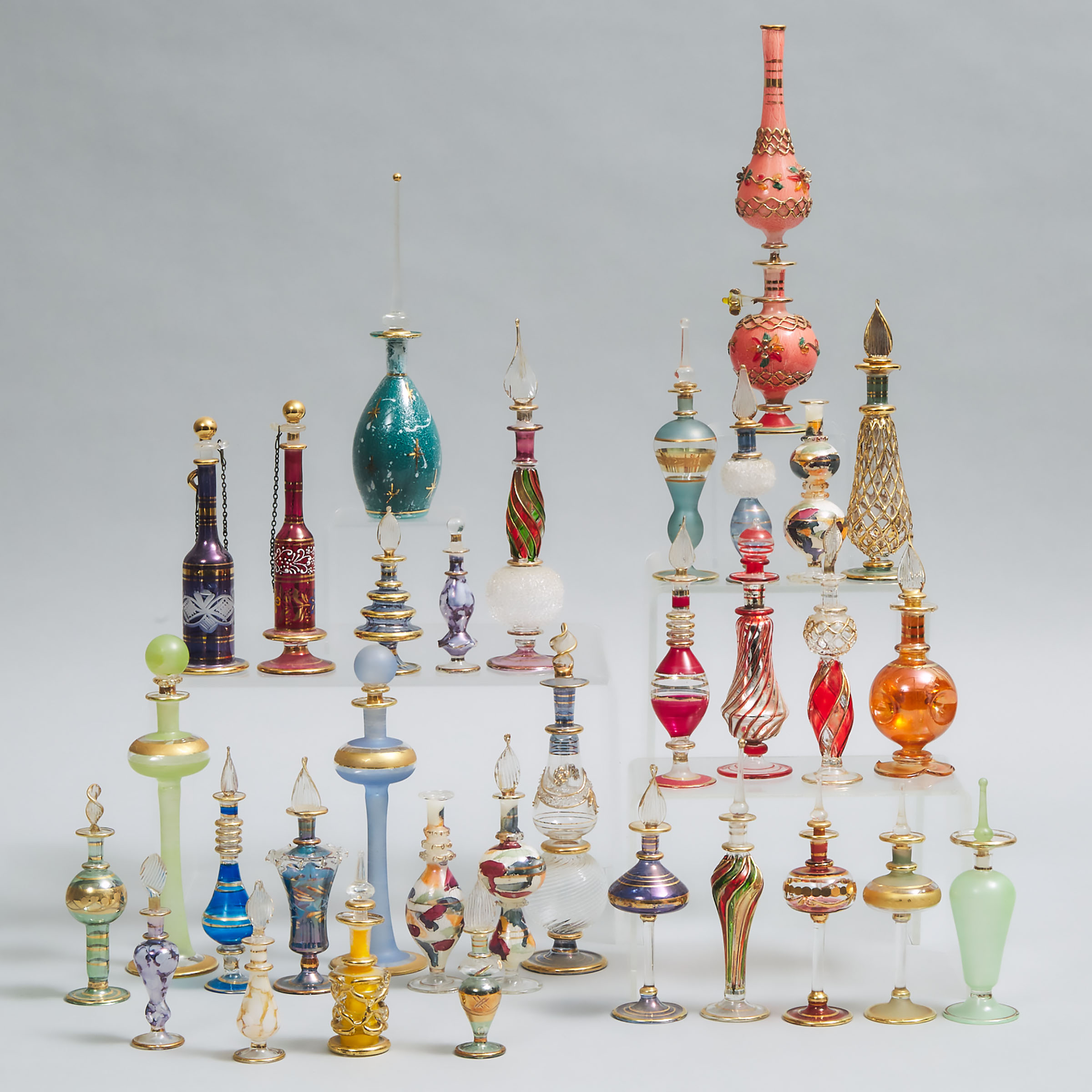 Thirty-Two Various Continental Gilt and Coloured Glass Perfume Bottles, 20th century