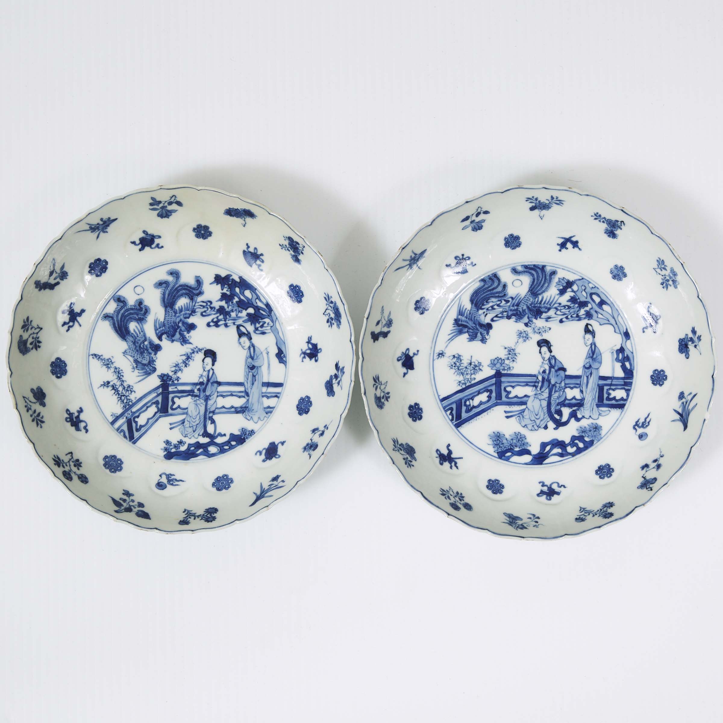 A Pair of Blue and White 'Ladies and Phoenix' Barbed Rim Dishes, Kangxi Period (1662-1722)