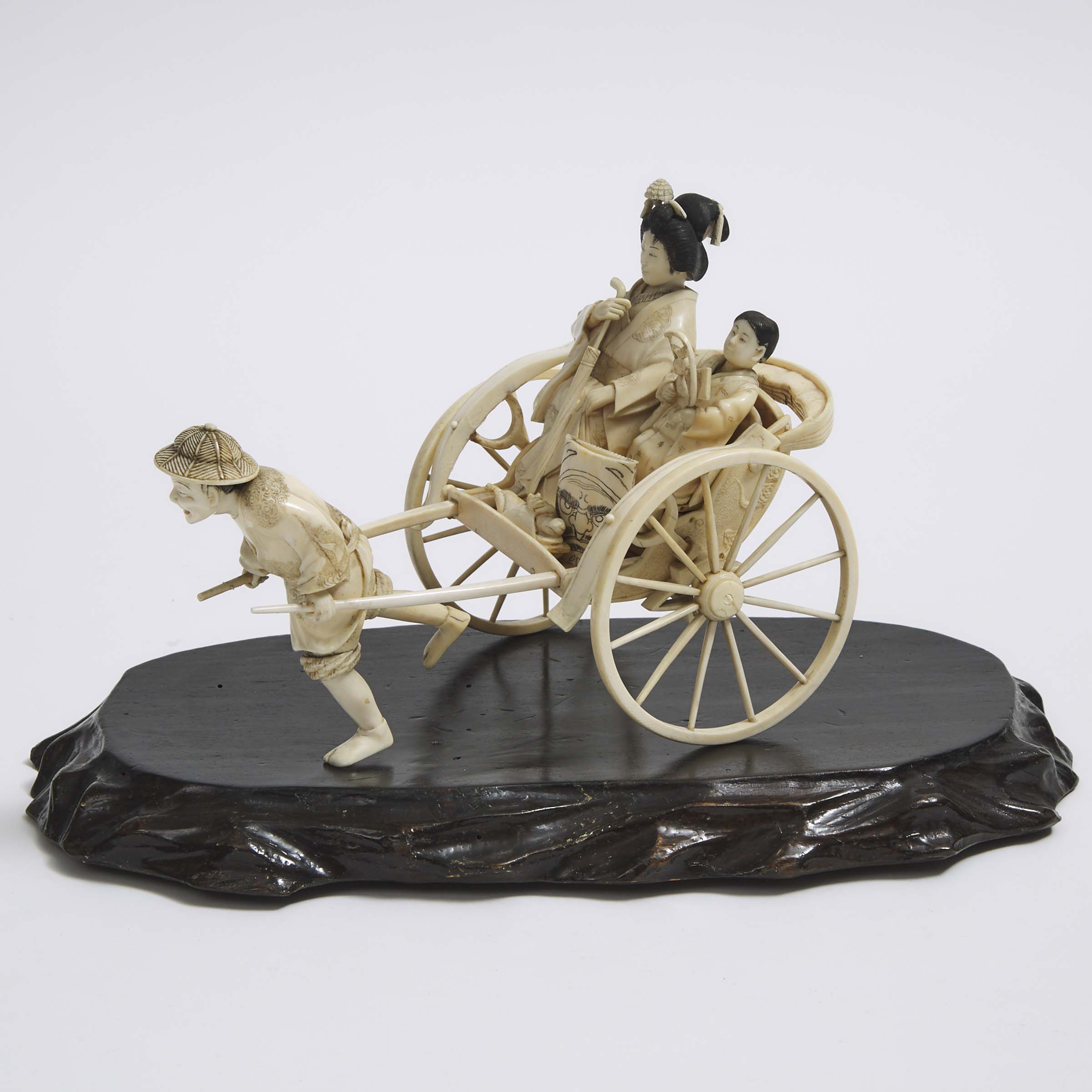 An Ivory Okimono of a Lady and Child in a Rickshaw, Meiji Period