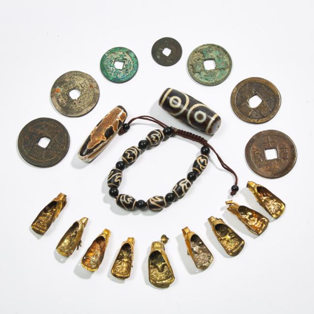 A Group of Nineteen Dzi Beads, Daoist Figure Fittings, and Coins