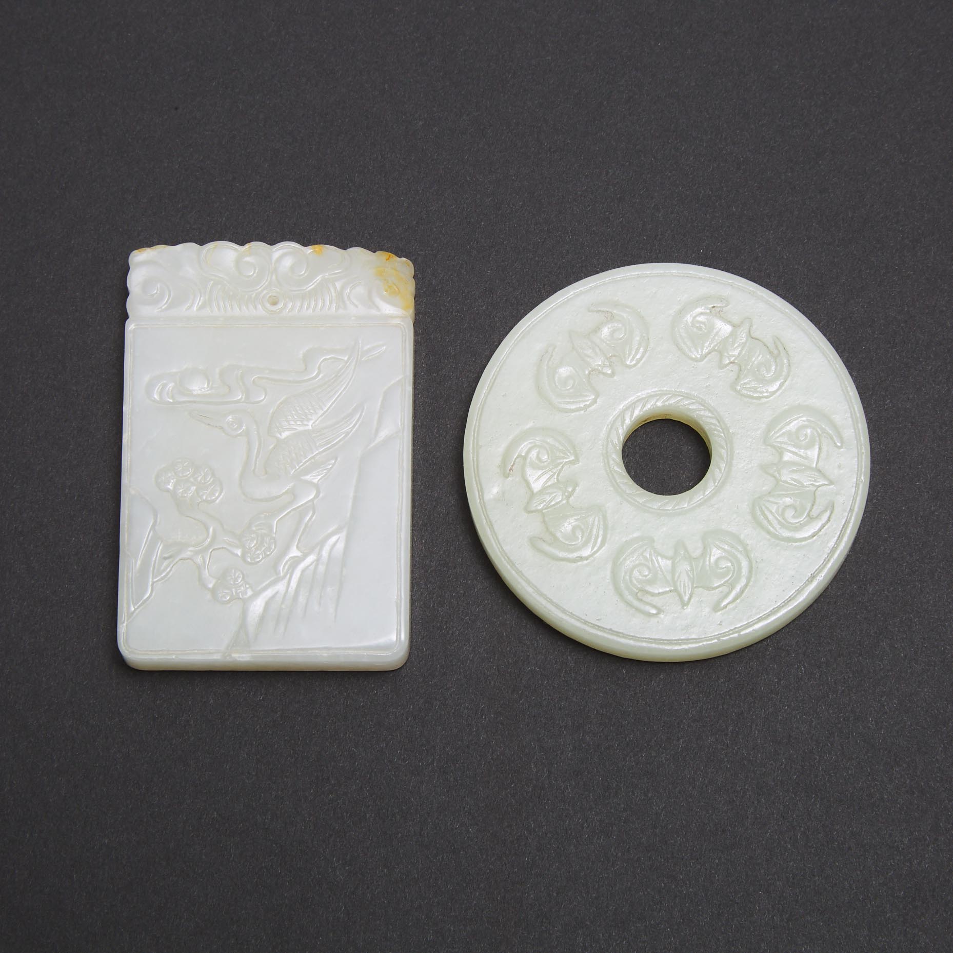 A White Jade 'Bats' Bi Disc, together with a White and Russet Jade 'Longevity' Plaque, 19th/20th Century 