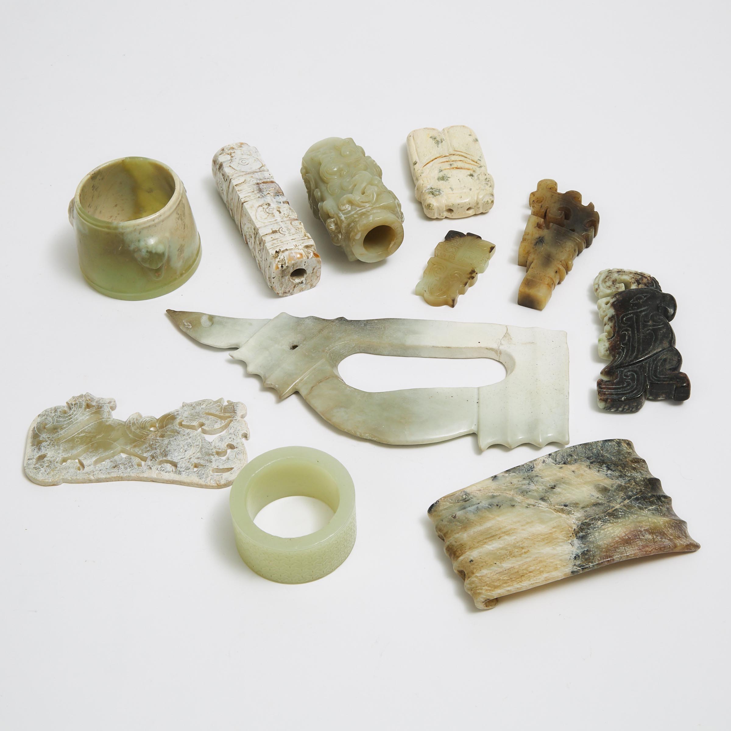 A Group of Eleven Chinese Archaic-Style Jade and Stone Carved Objects