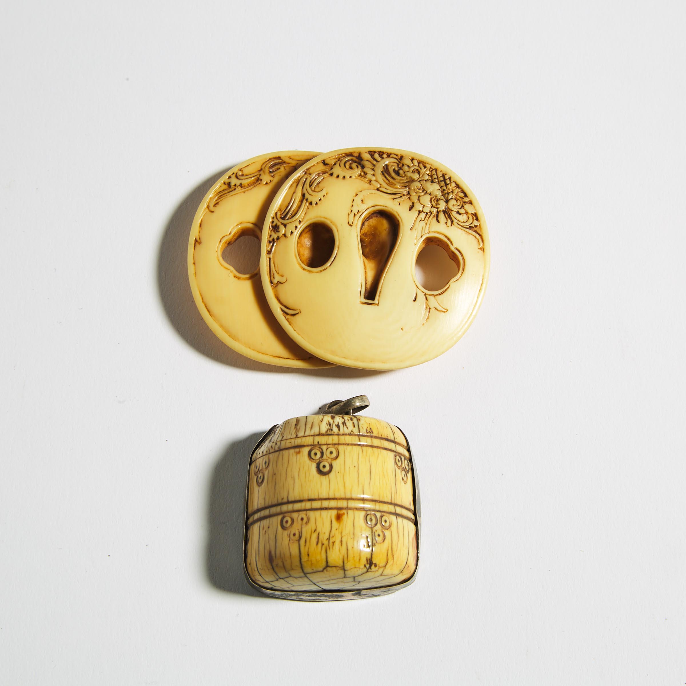 An Ivory Netsuke of a Pair of Tsuba, together with an Metal-Mounted Toggle, Meiji Period
