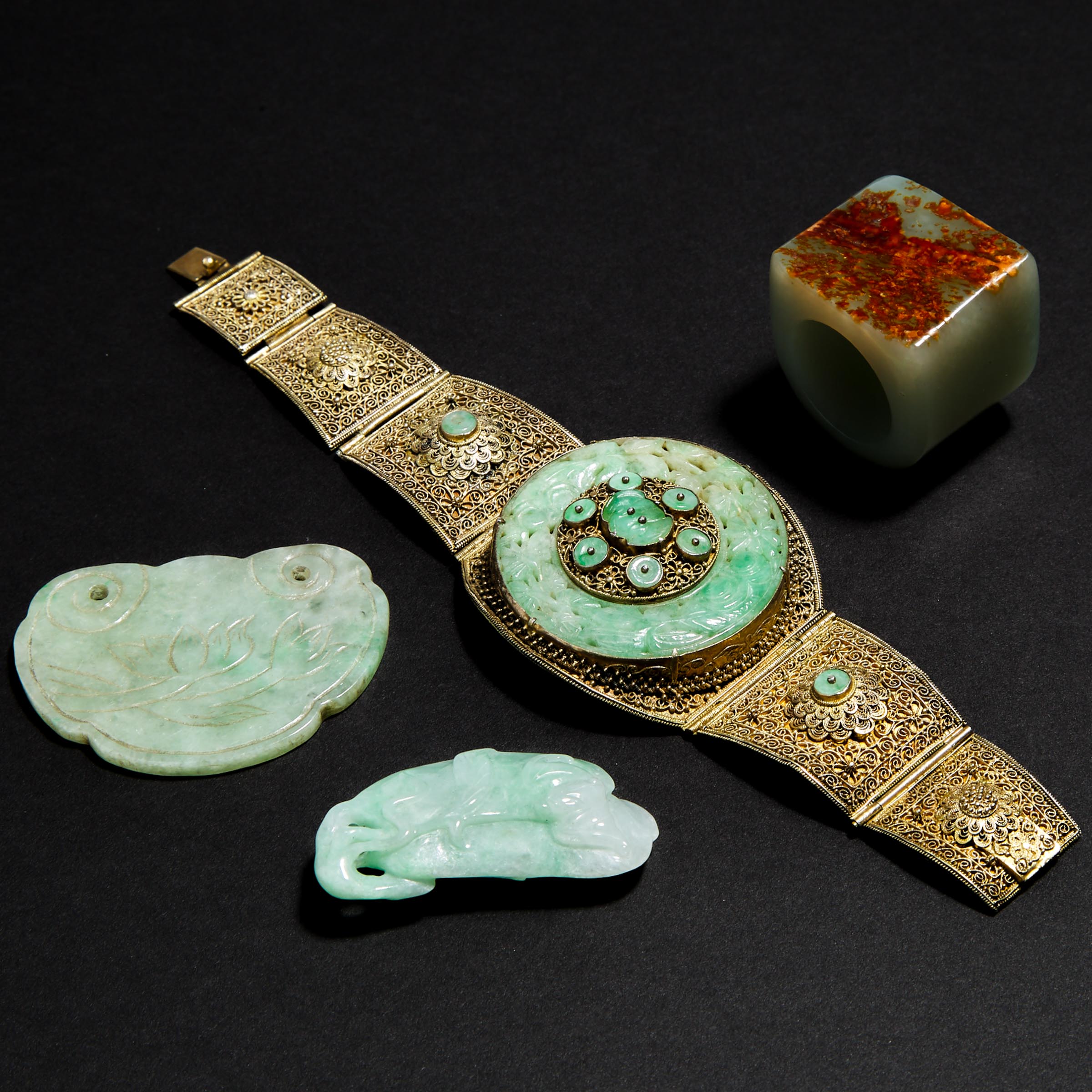 A Silver-Gilt Filigree and Jadeite Bangle, together with Two Jadeite Pendants and a Pale Celadon Jade Archer Ring
