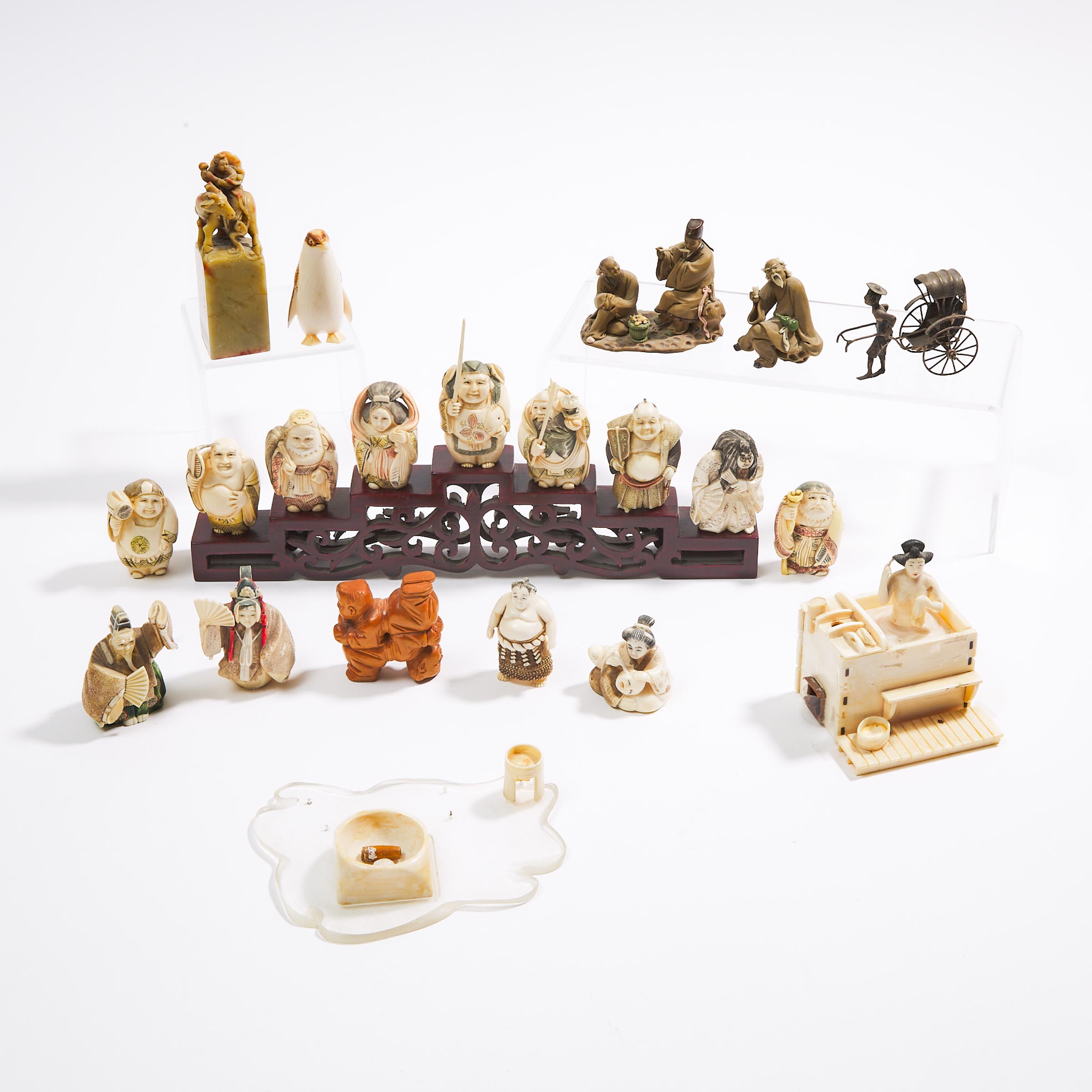 A Group of Twenty-Two Japanese Ivory Netsuke and Other Miscellaneous Pieces