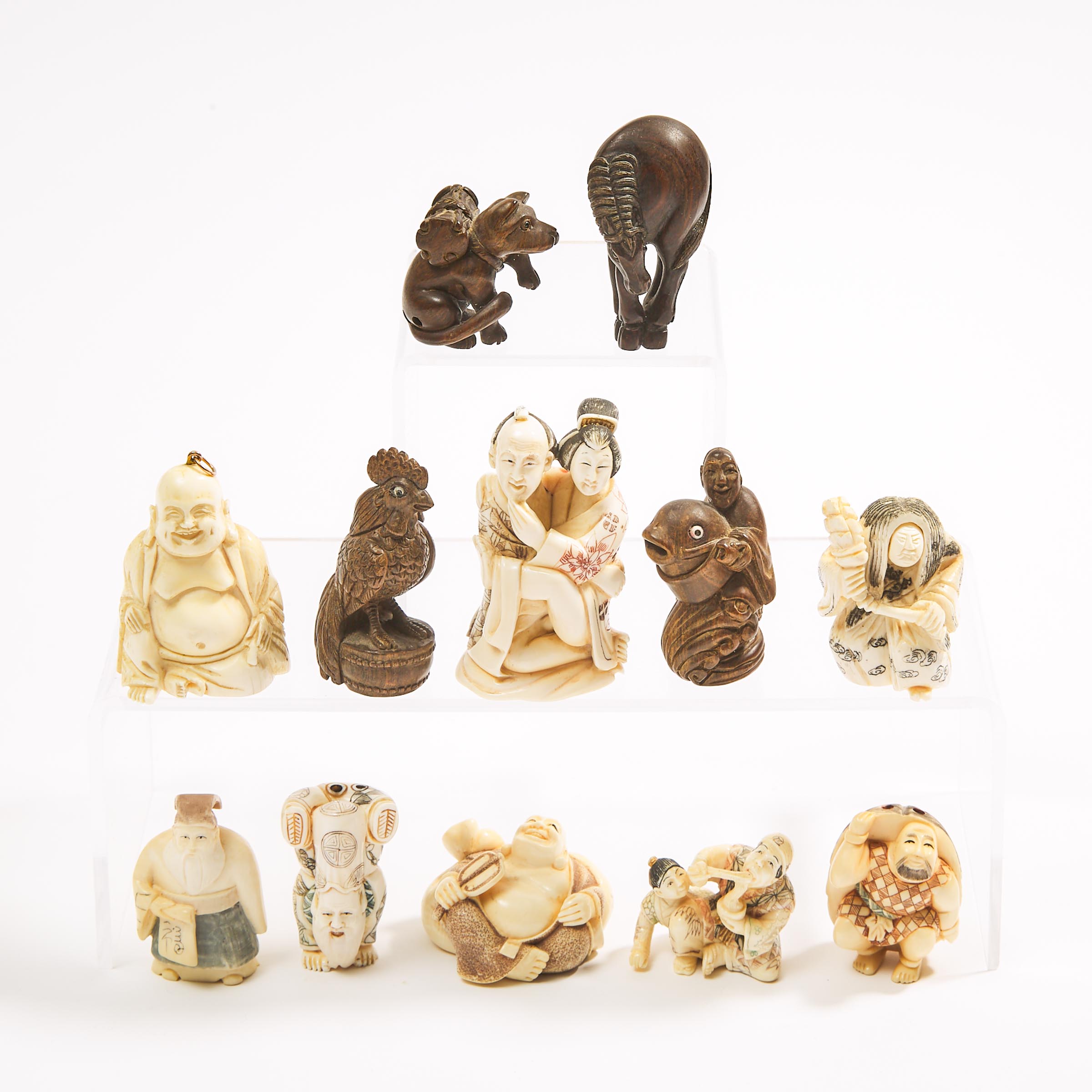 A Group of Twelve Ivory and Wood Netsuke