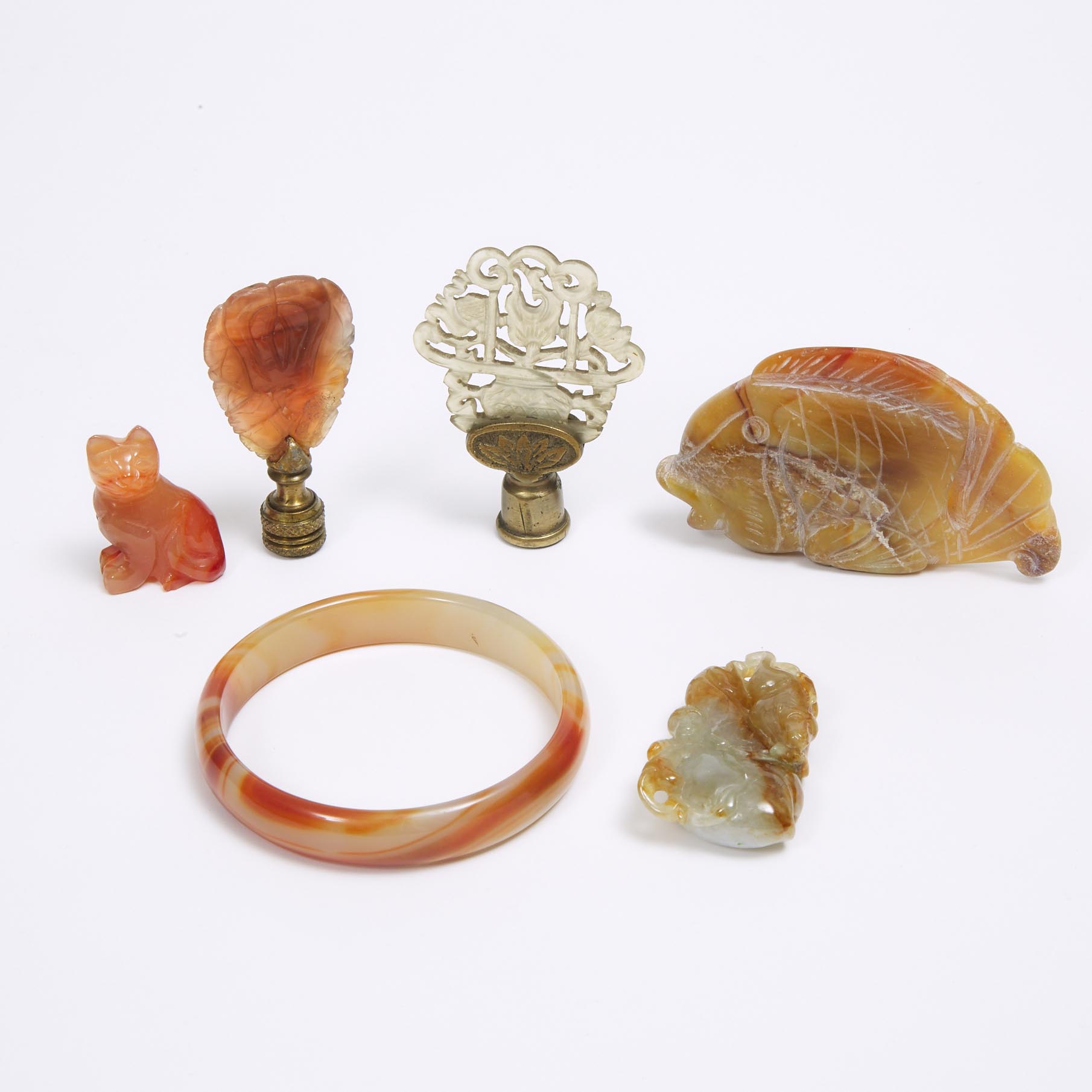 A Group of Six Carnelian and Hardstone Carvings
