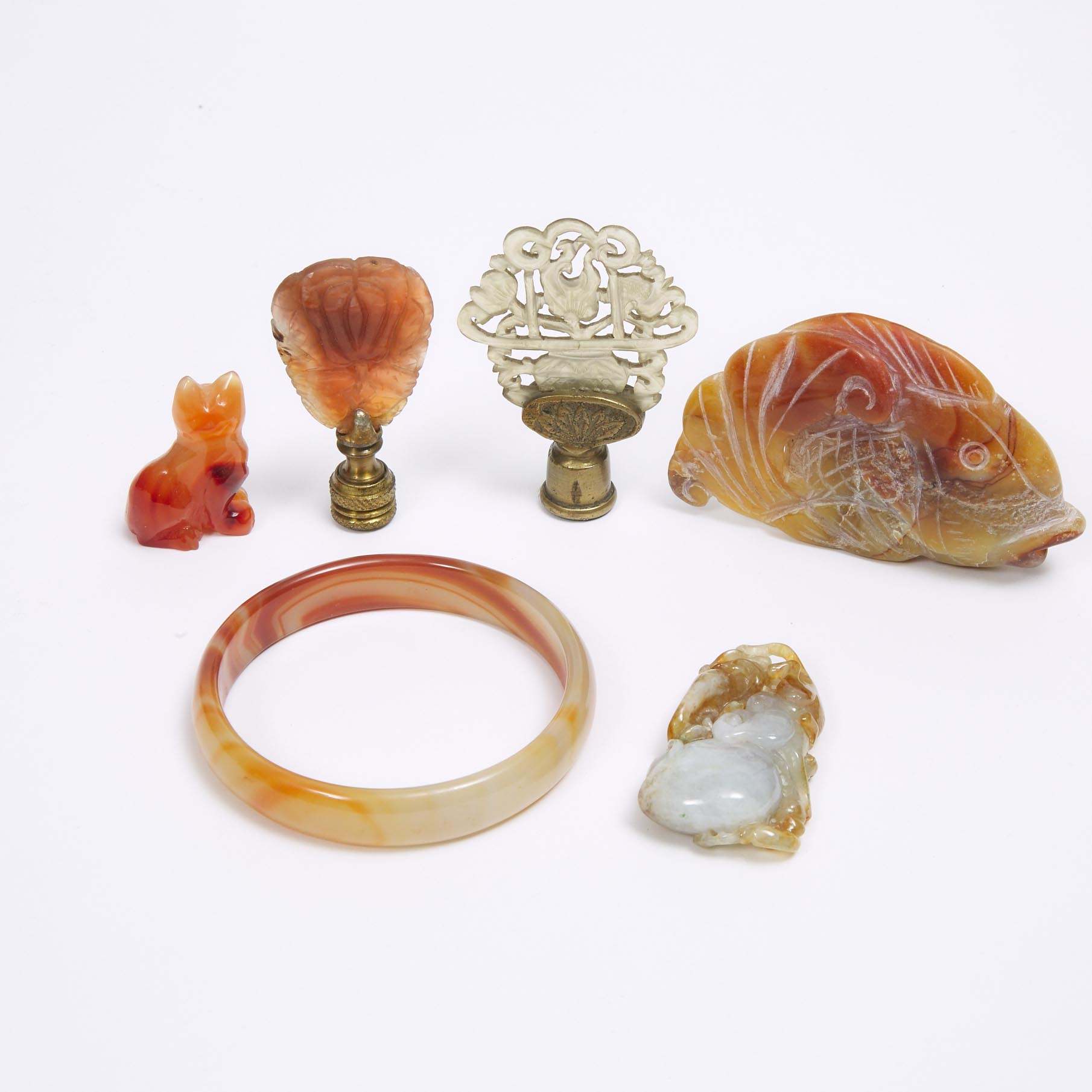 A Group of Six Carnelian and Hardstone Carvings