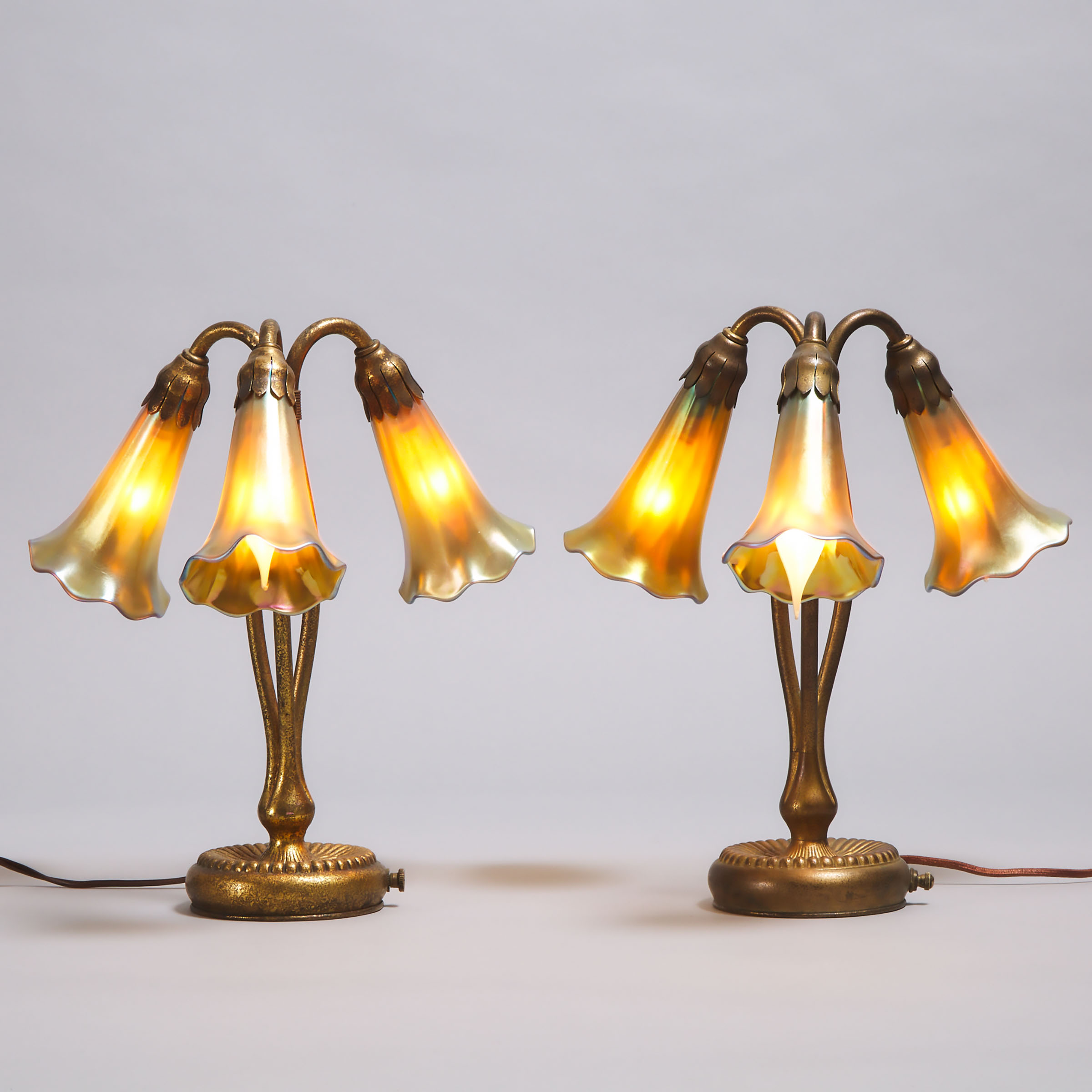 Pair of Tiffany Studios, New York, Gilt Bronze Three Light Table Lamps, c.1904 and later