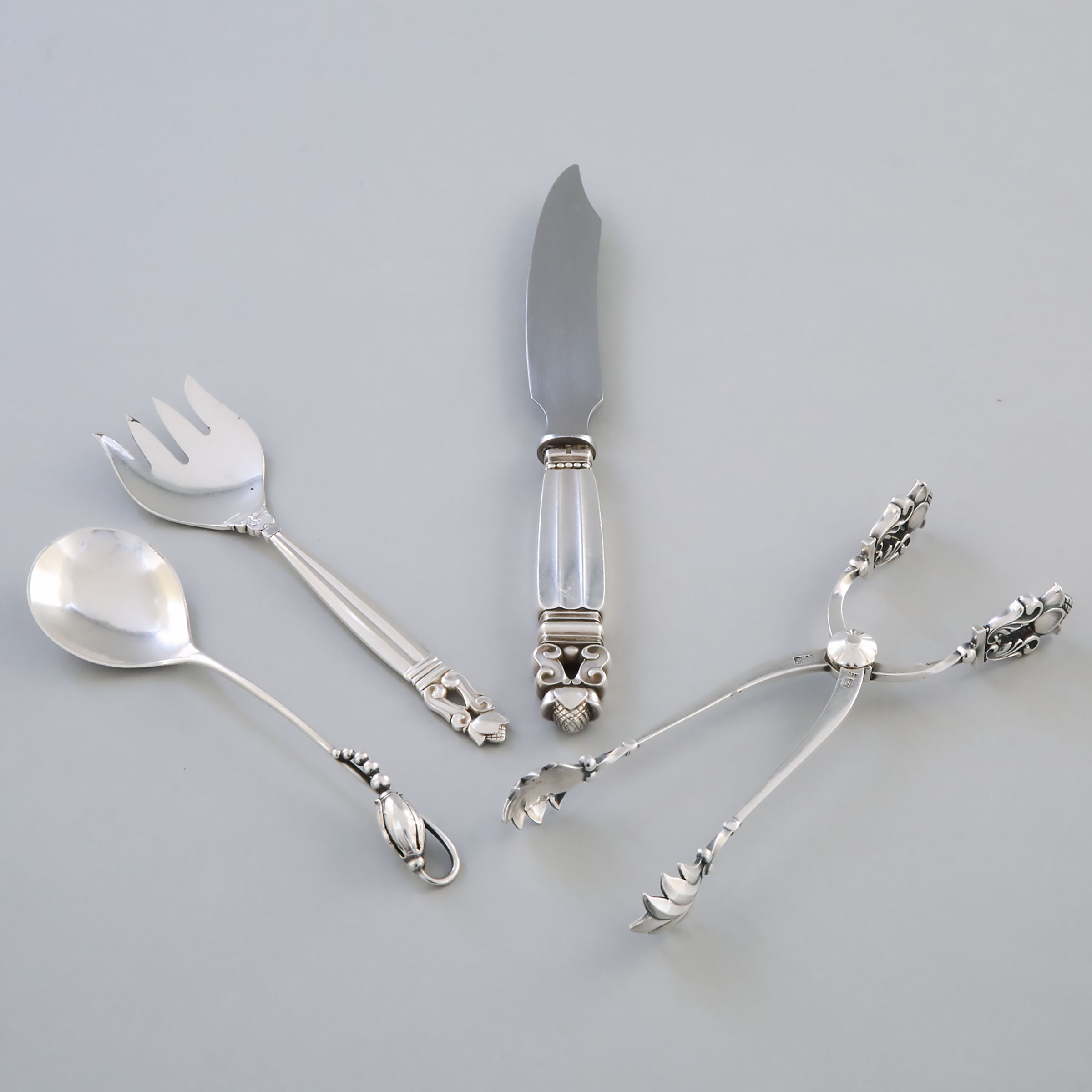 Danish Silver ‘Acorn’ Pattern Cheese Knife, Sardine Fork and Sugar Tongs, and a 'Blossom' Pattern Spoon, Georg Jensen, Copenhagen, c.1933-44