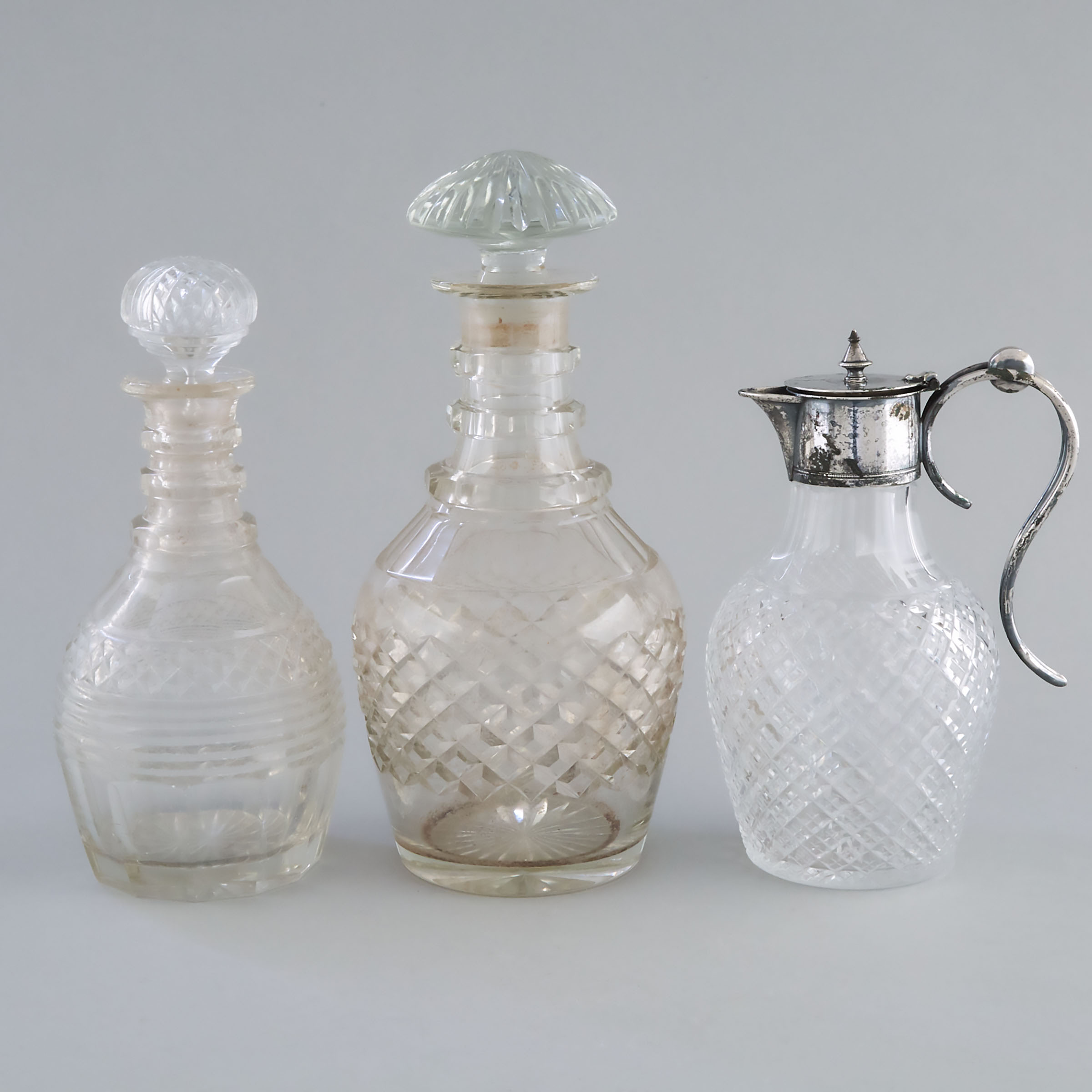 Two Anglo-Irish Cut Glass Decanters and a Silver Plate Mounted Claret Jug, 19th century