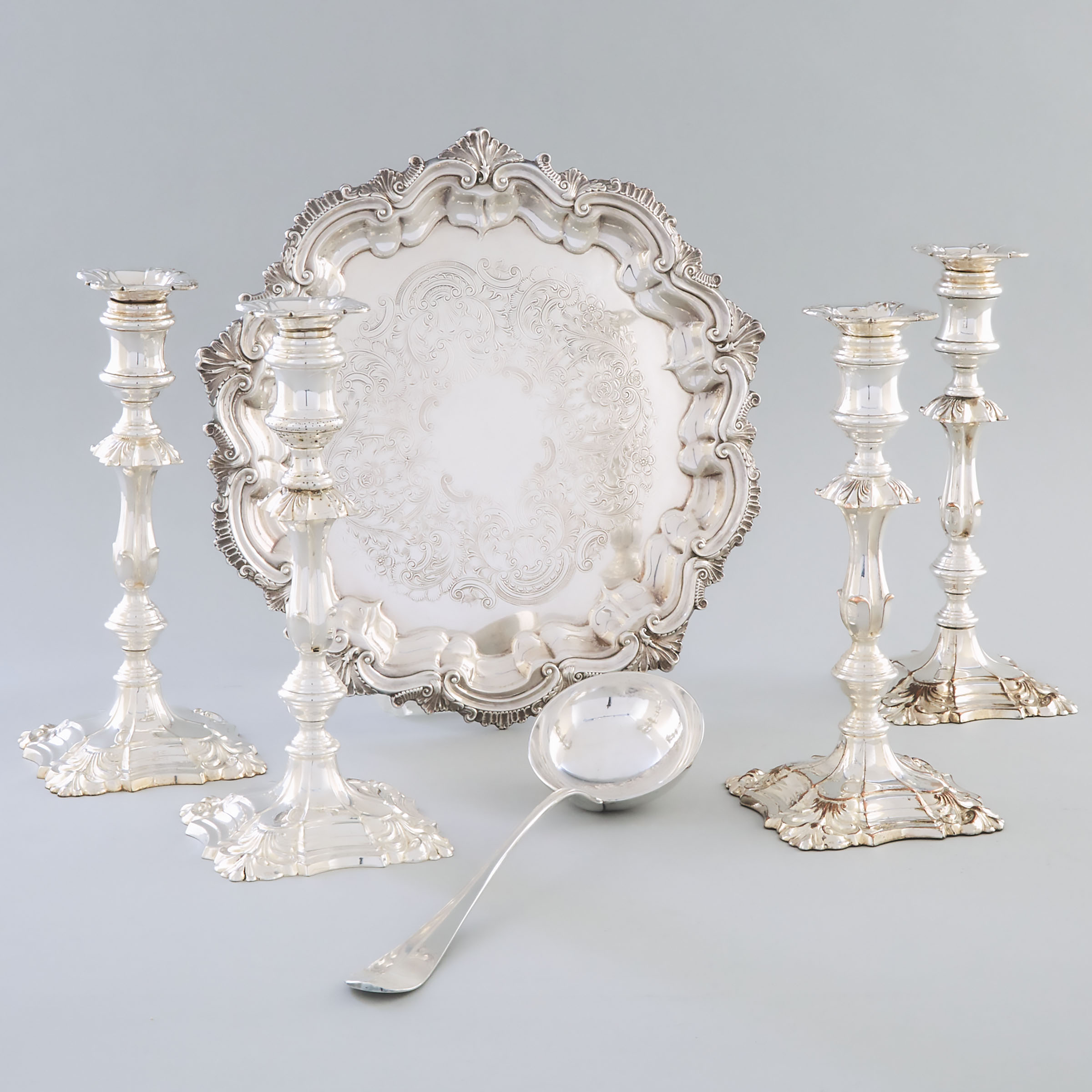 Set of Four English Silver Plated Table Candlesticks, Shaped Circular Salver and a Christofle Soup Ladle, 20th century