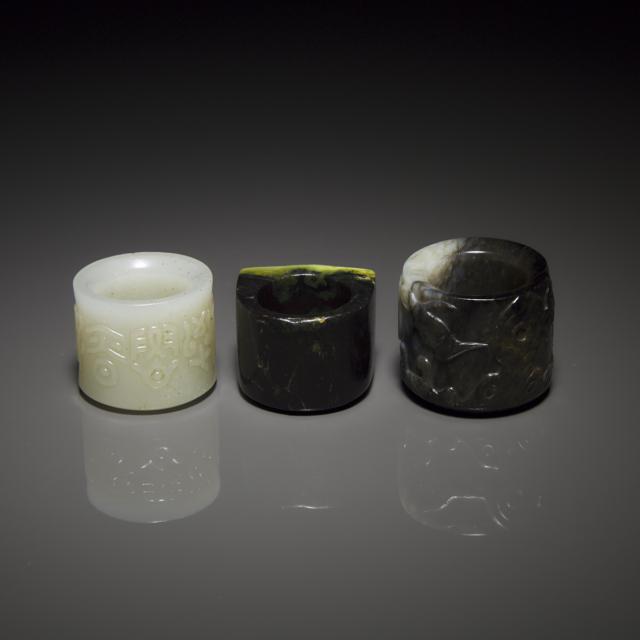 A Group of Three Jade and Jadeite Carved Archer Rings, 19th Century