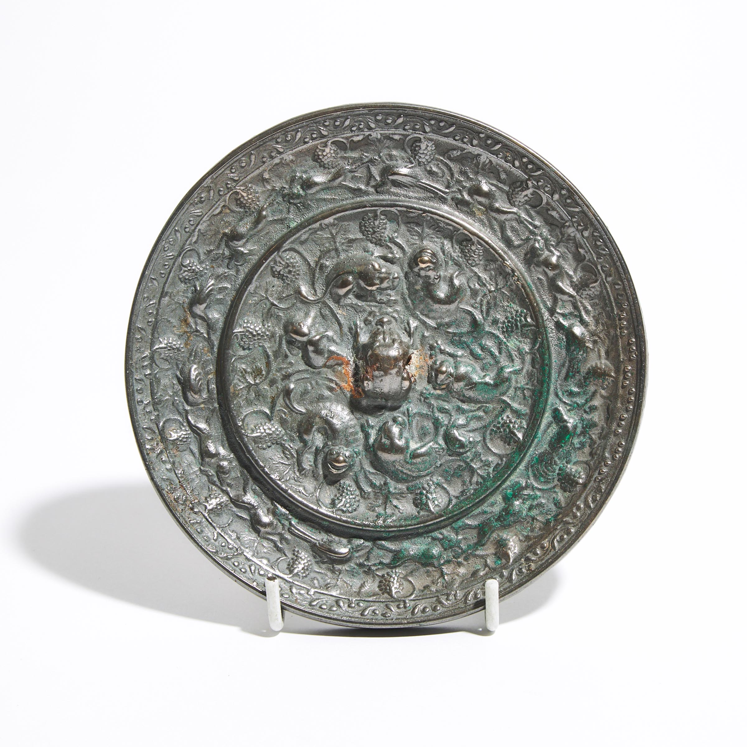 A Silvery Bronze 'Lion And Grapevine' Mirror, Tang Dynasty (AD 618-907)