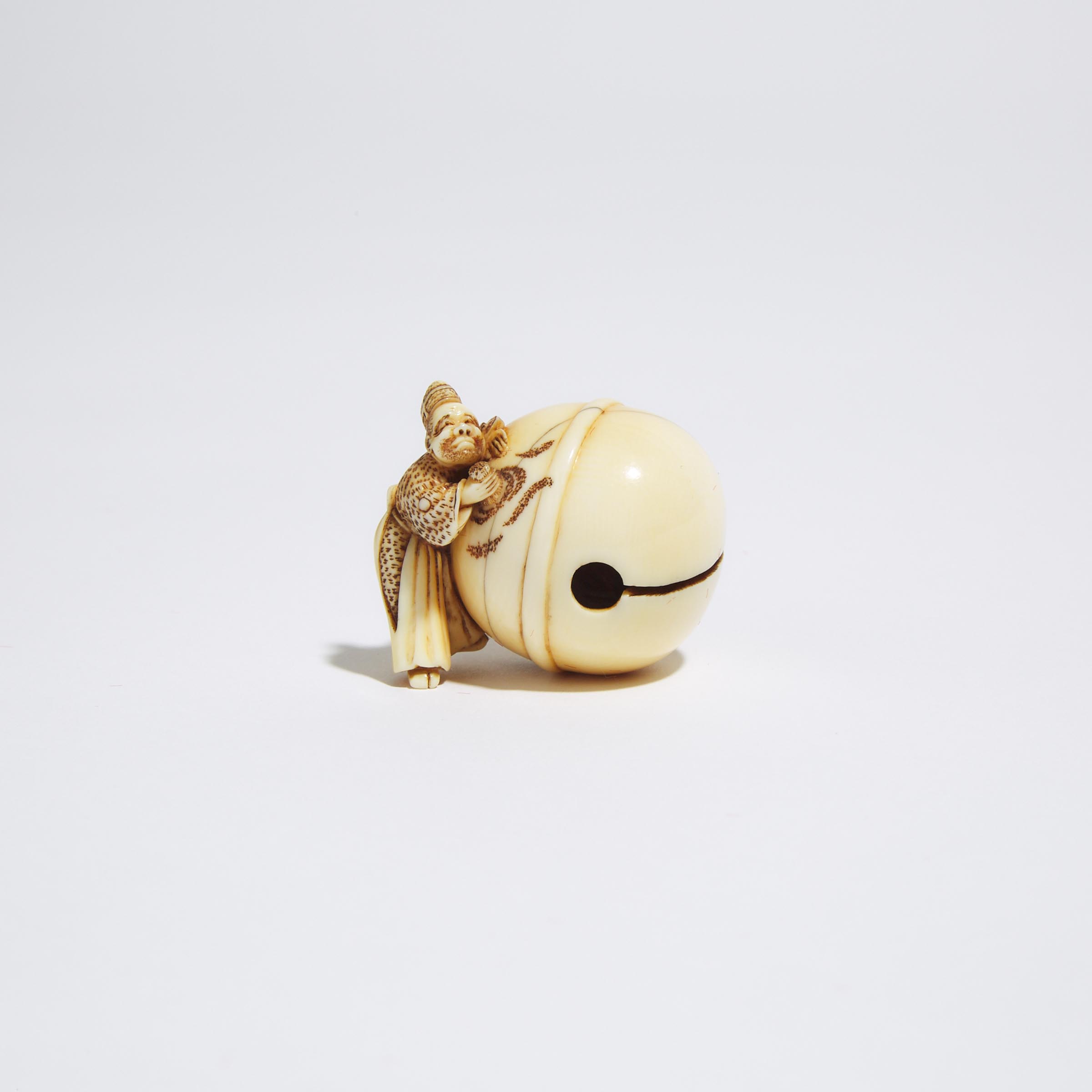 An Ivory Netsuke of a Priest Cleaning a Large Bell, Signed Shuosai, Edo/Meiji Period, 19th Century