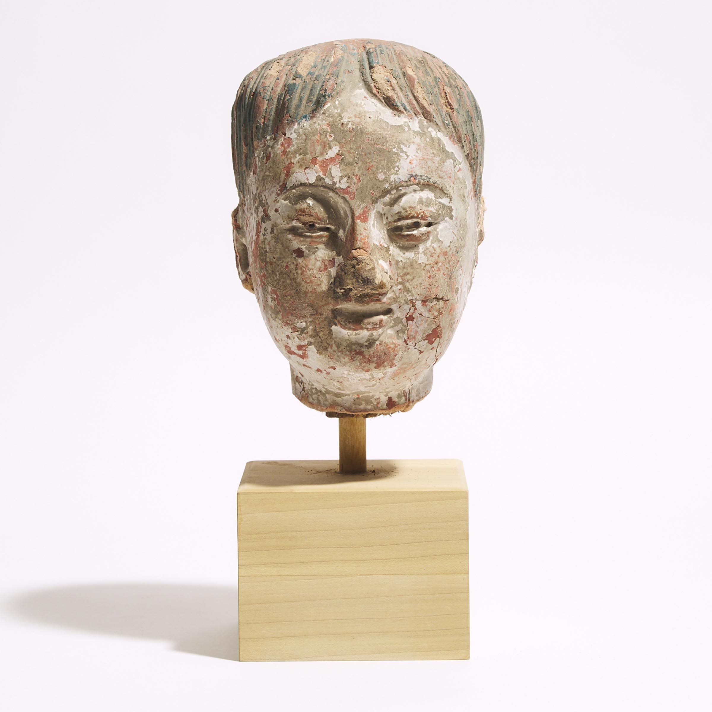 A Polychrome Stucco Head of a Boy, Ming Dynasty (1368-1644)