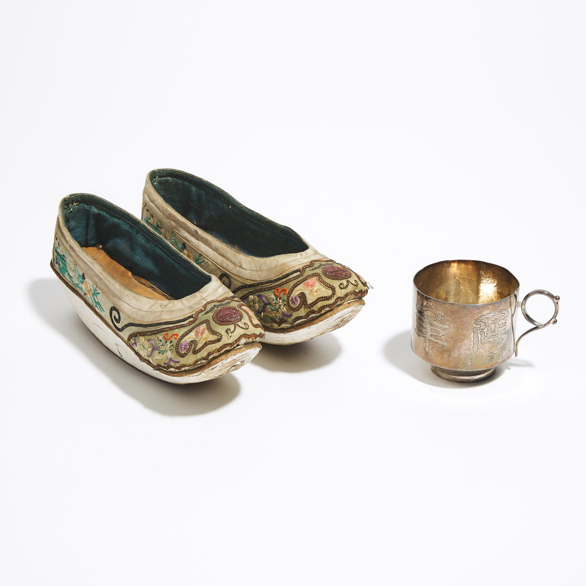 A Pair of Chinese Silk Embroidered Ladies' Shoes, together with a Silver Tea Cup, Late Qing Dynasty