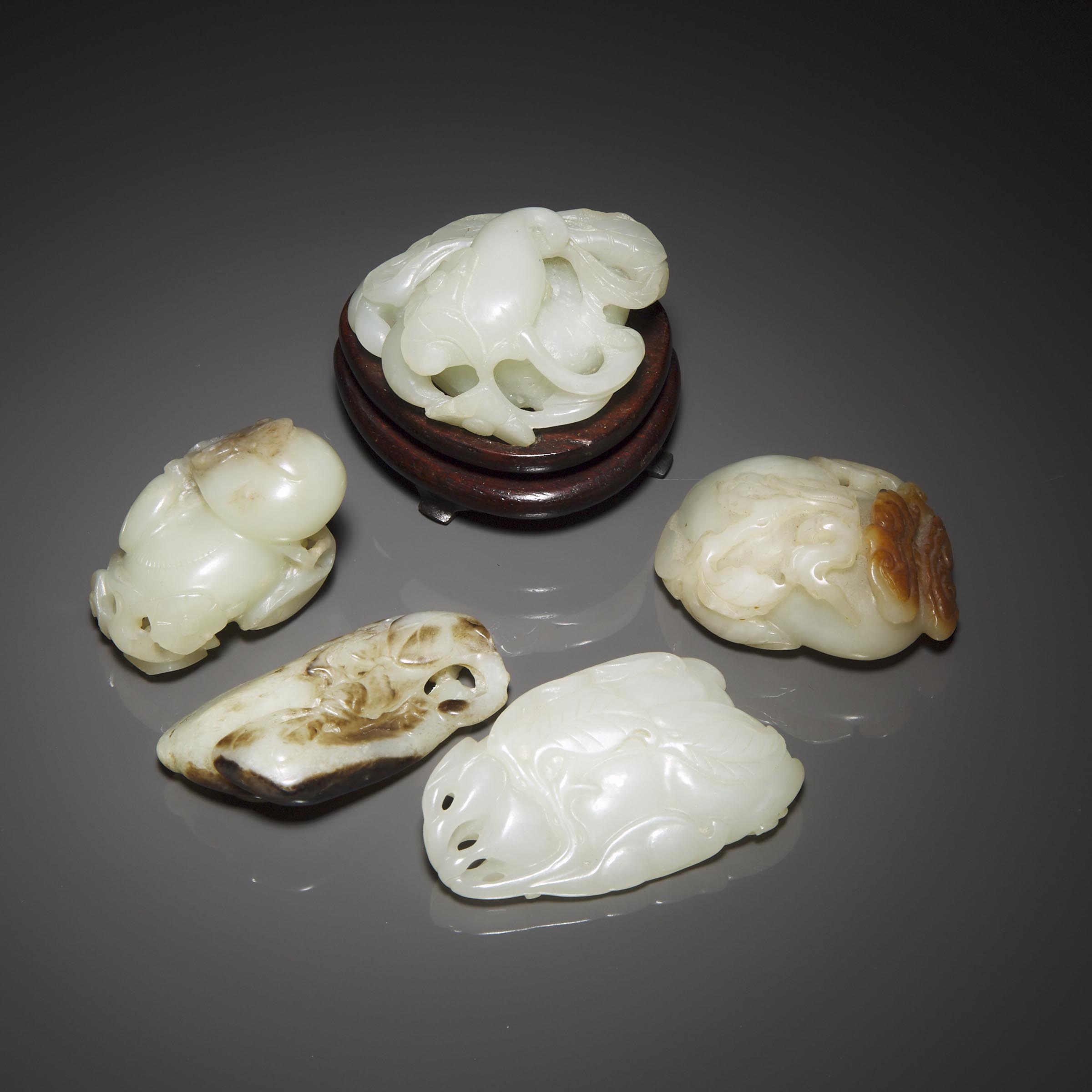 A Group of Five White and Russet Jade Carvings, Qing Dynasty