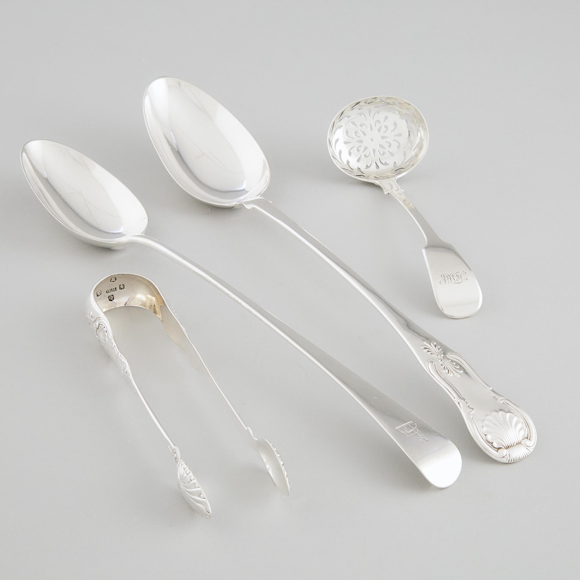 Two Georgian Silver Serving Spoons, William Sumner I, London, 1801 and Marshall & Sons, Edinburgh, 1821, Sugar Tongs, William Russell II, Glasgow, 1833, and a Sifting Ladle, William Bateman II, London, 1835