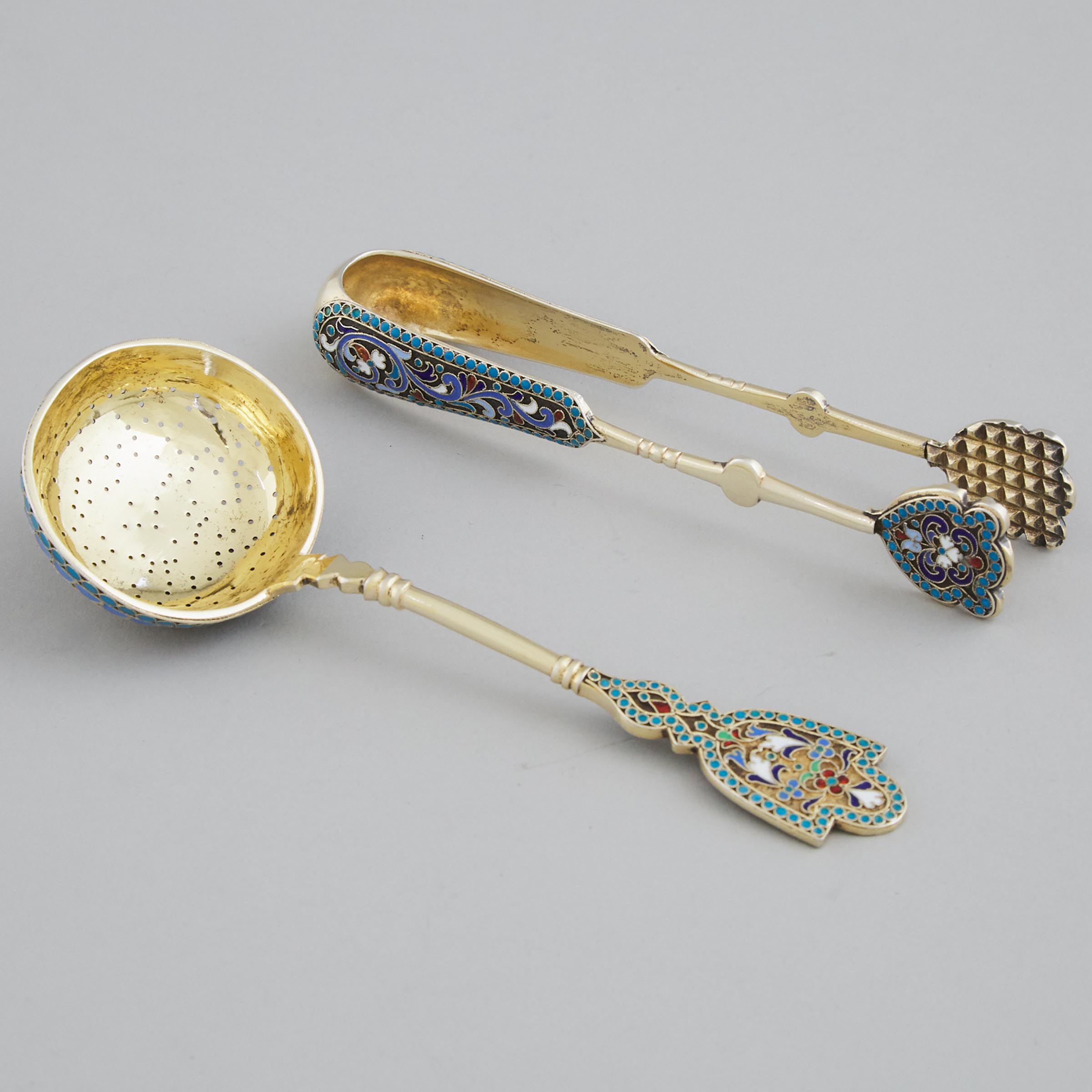 Russian Silver-Gilt and Cloisonné Enamel Sugar Tongs and a Sifting Ladle, Gustav Klingert and probably Ivan Saltikov, Moscow, late 19th century