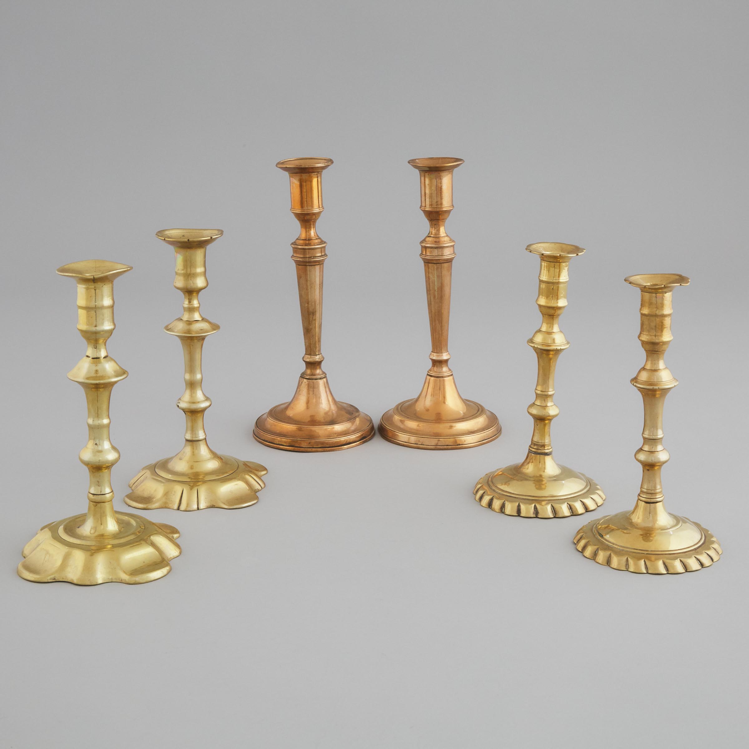 Three Pairs of English Brass or Copper Candlesticks, mid 18th-early 19th centuries