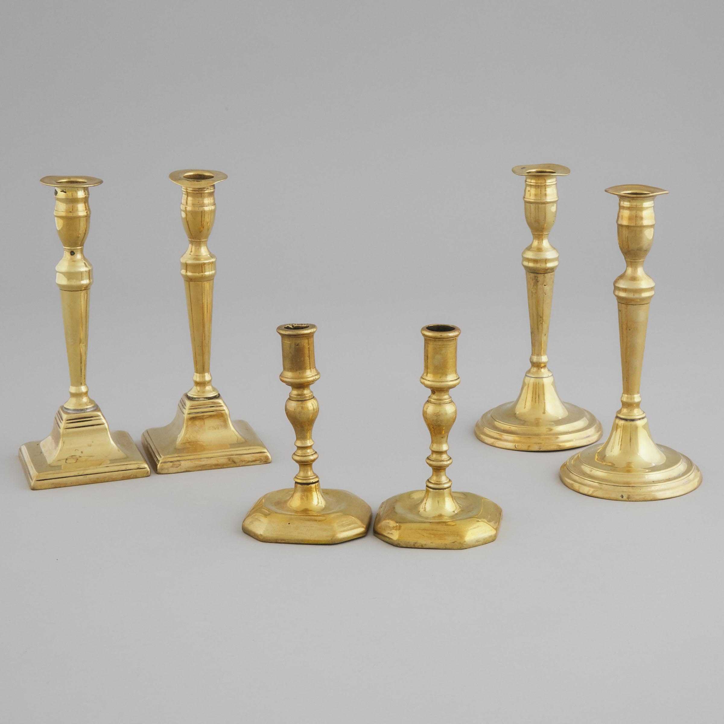 Three Pairs of English Brass Candlesticks, early 18th - early 19th centuries
