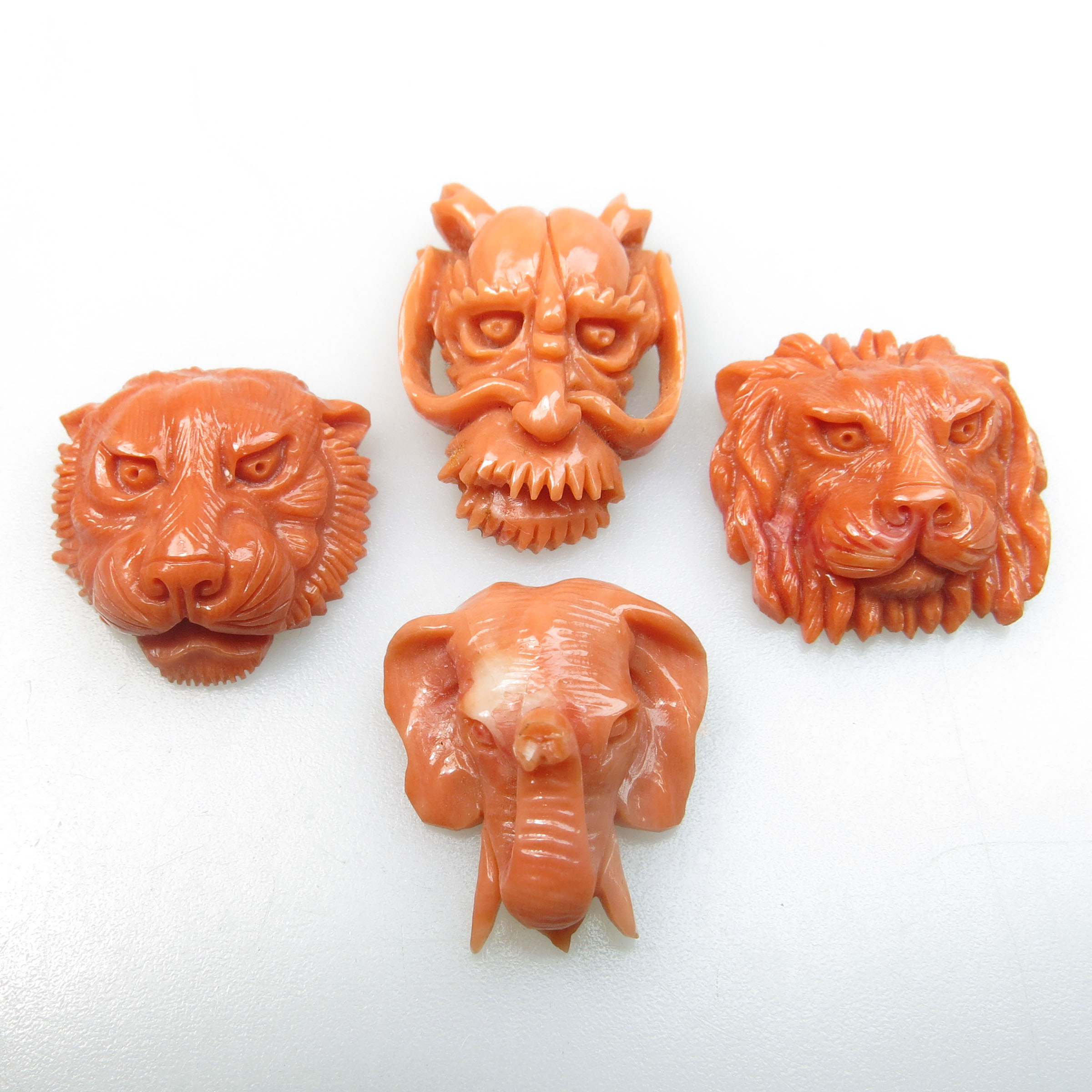 4 Carved Coral Animal Heads