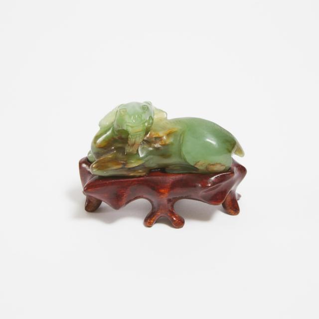 A Green and Russet Jade Carving of a Recumbent Ram, Qing Dynasty