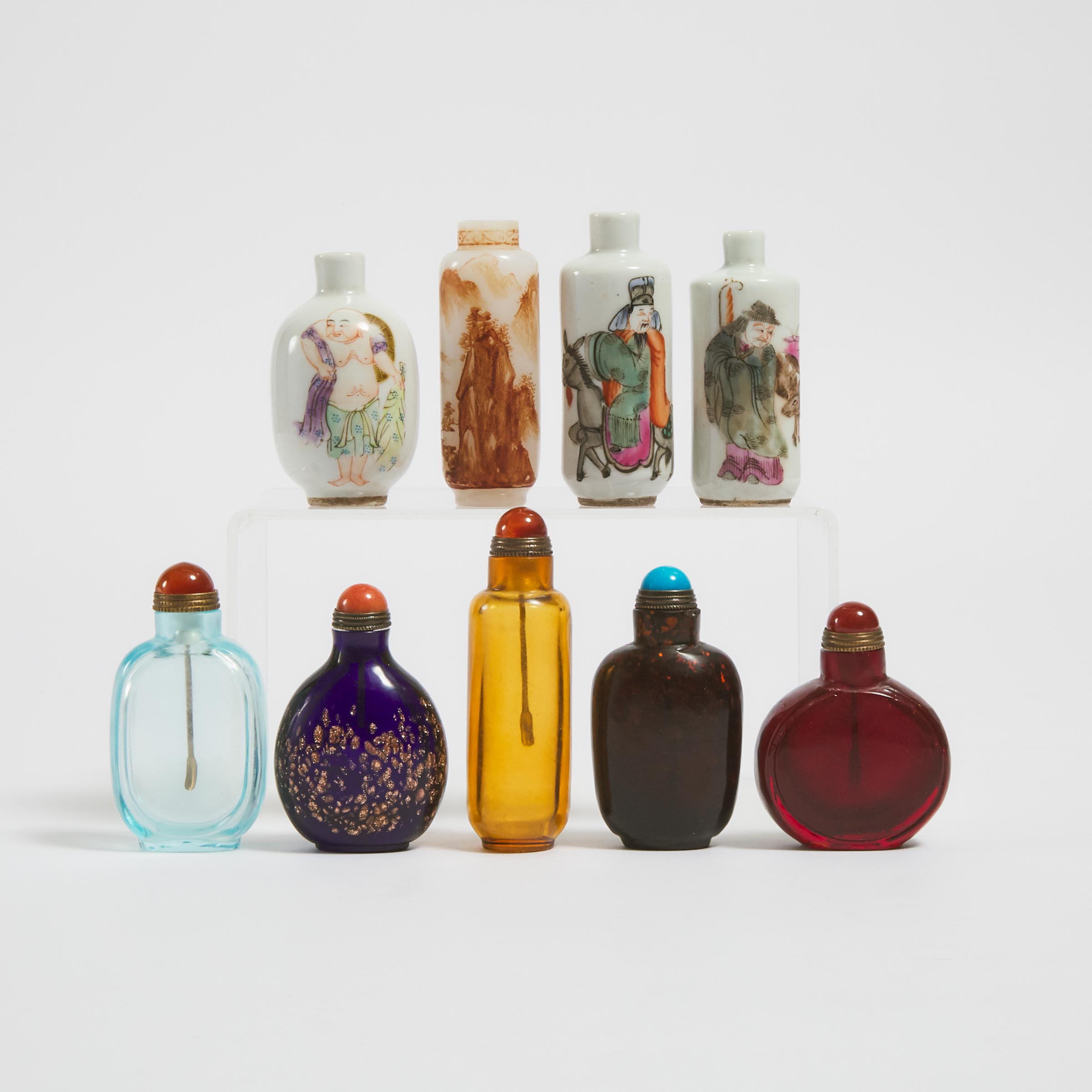A Group of Nine Porcelain and Glass Snuff Bottles, 19th Century and Later