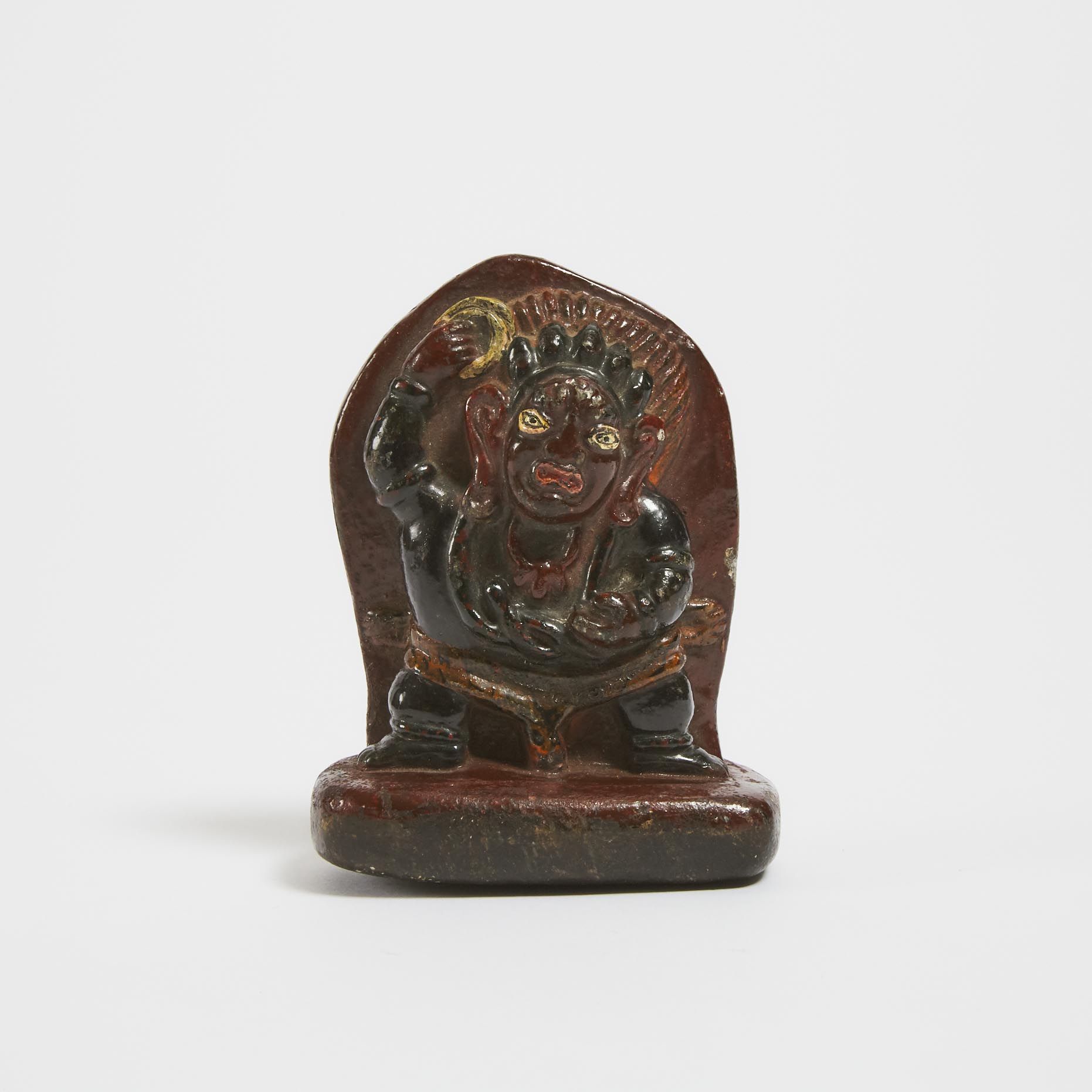 A Tibetan Polychromed and Carved Stone Figure of a Wrathful Deity, Possibly 15th Century