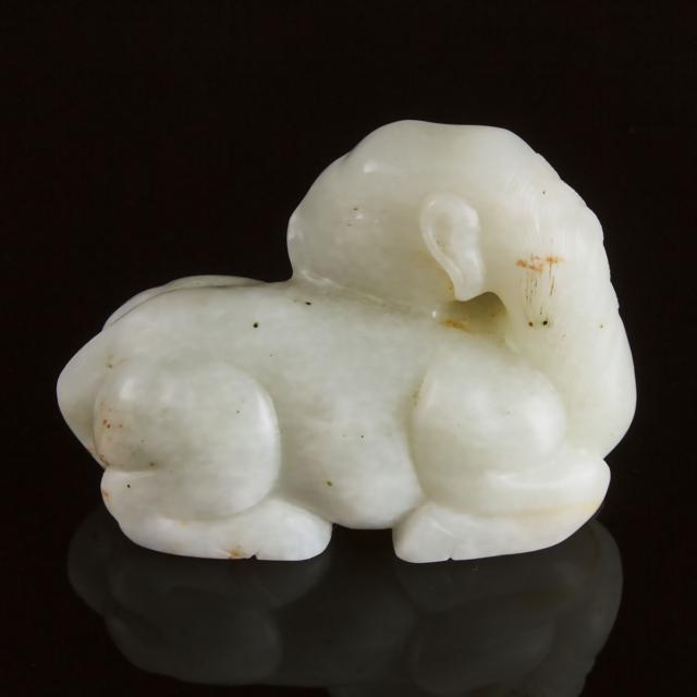 A Mottled White Jade Carving of a Recumbent Ram, Ming Dynasty, 17th Century
