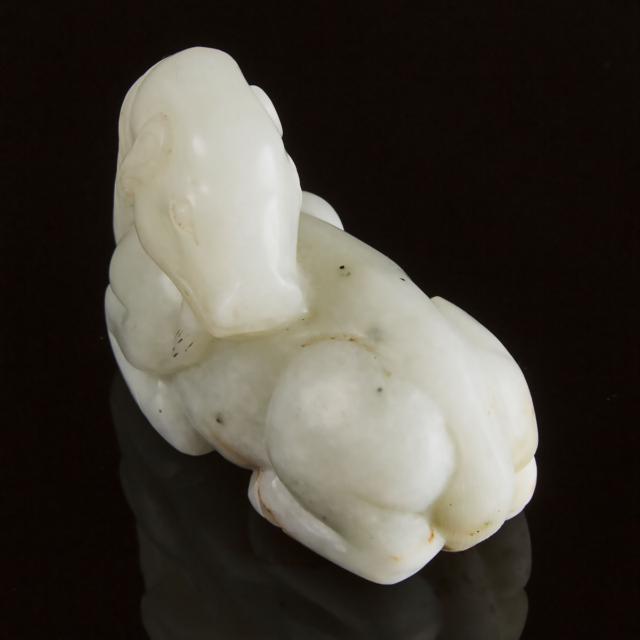 A Mottled White Jade Carving of a Recumbent Ram, Ming Dynasty, 17th Century