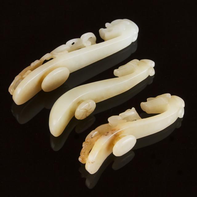 A Group of Three White and Pale Russet Jade Belt Hooks