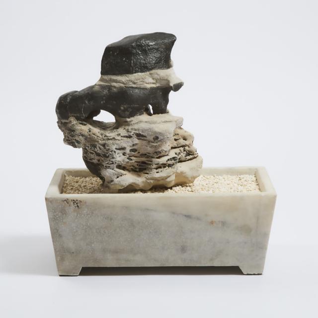 A Chinese Lingbi Scholar's Rock in a Marble Jardinière