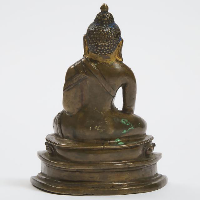 A Silver and Copper Inlaid Bronze Buddha, Tibet, 14th Century