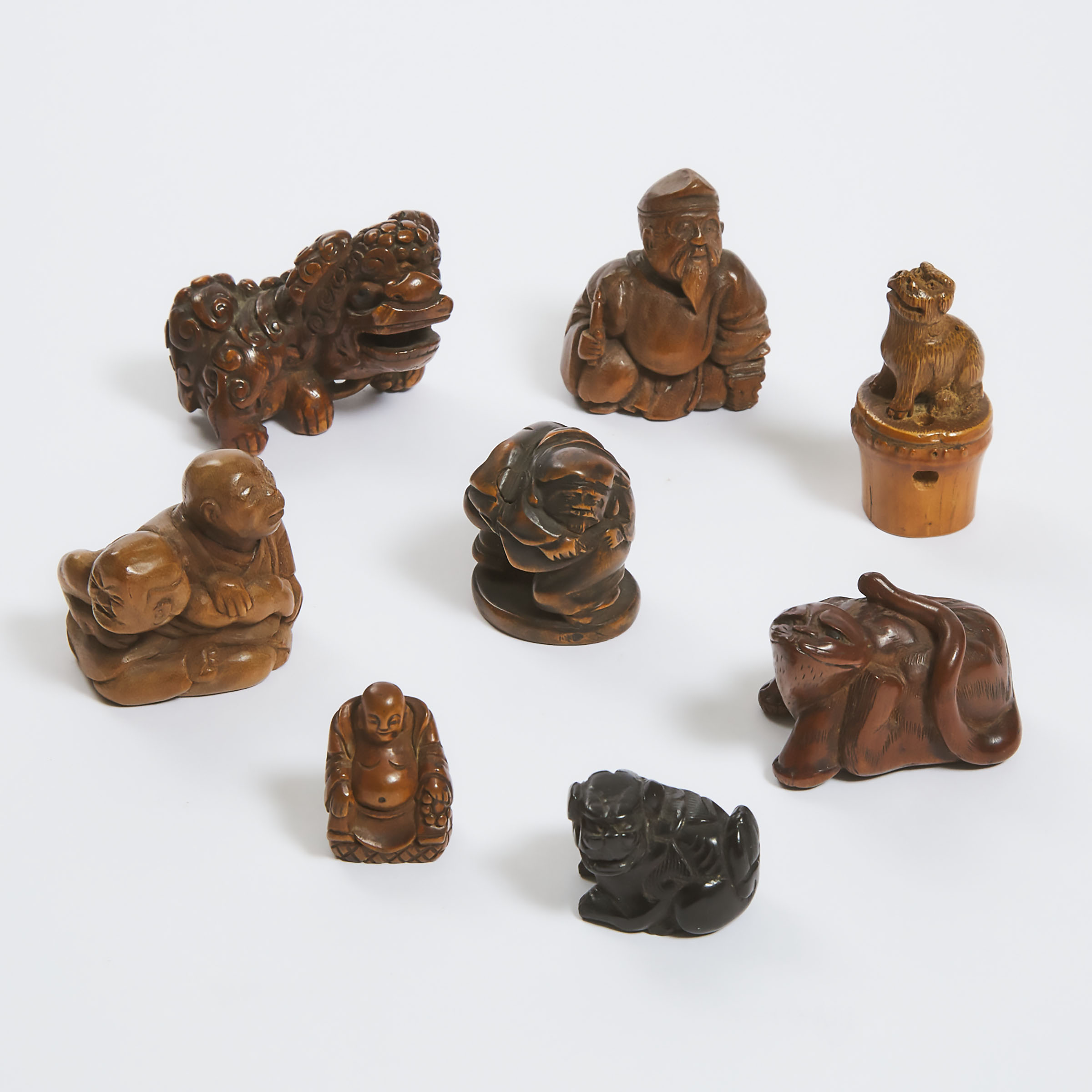 A Group of Eight Boxwood and Bamboo Netsuke and Carvings, 19th Century and Later