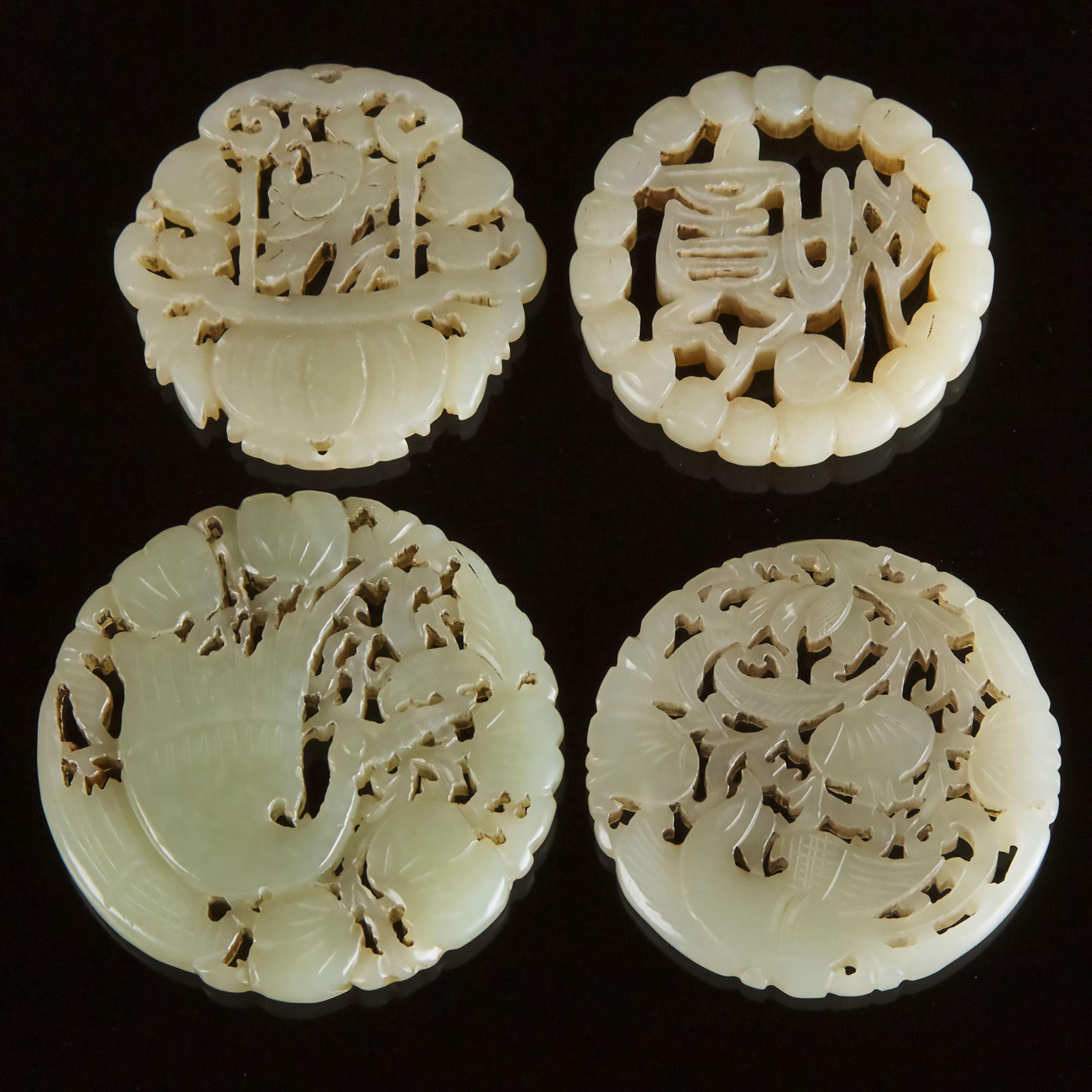 A Group of Four Pale Celadon Jade Circular Plaques