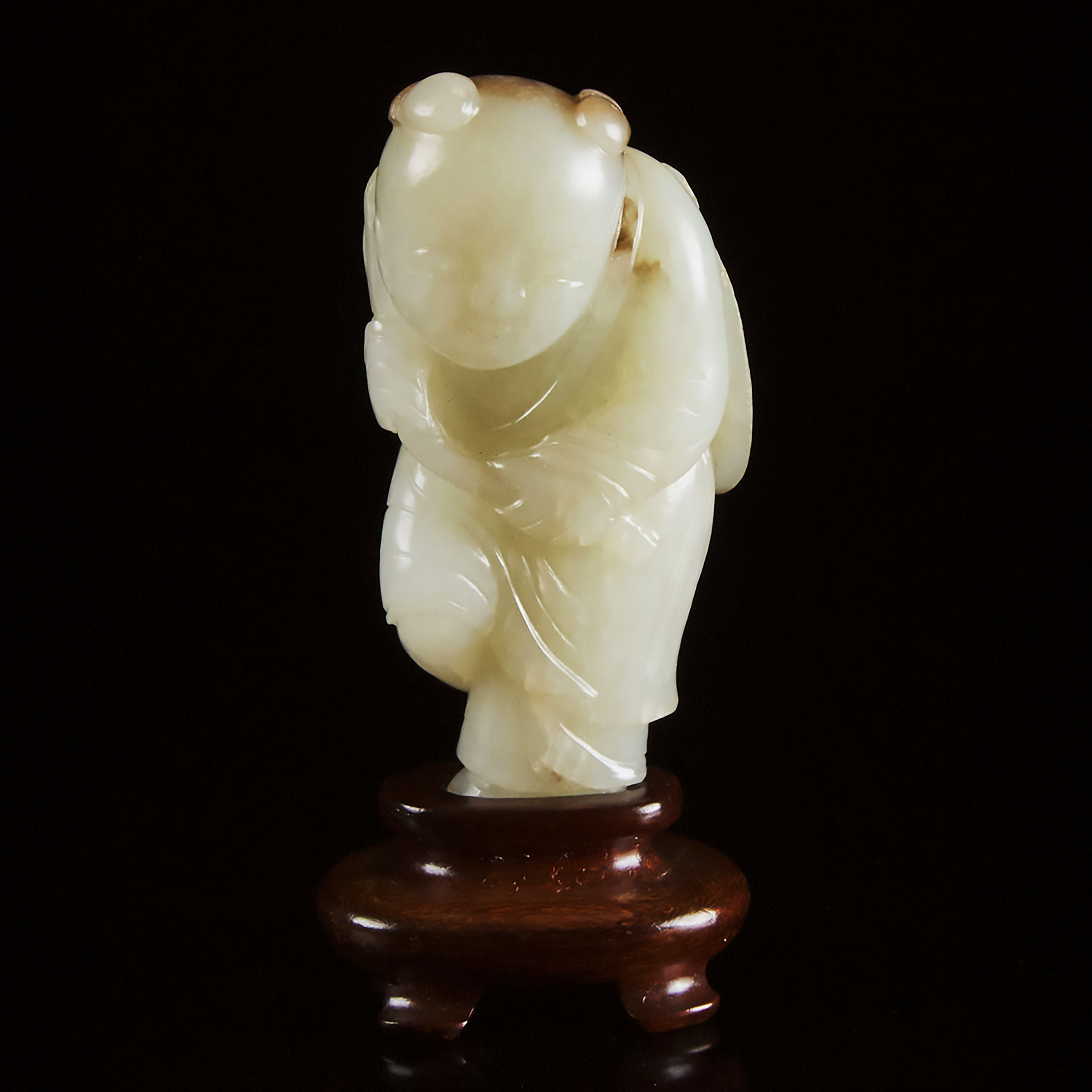A White and Russet Jade Carving of a Boy Holding Lingzhi, Qing Dynasty, Late 19th Century