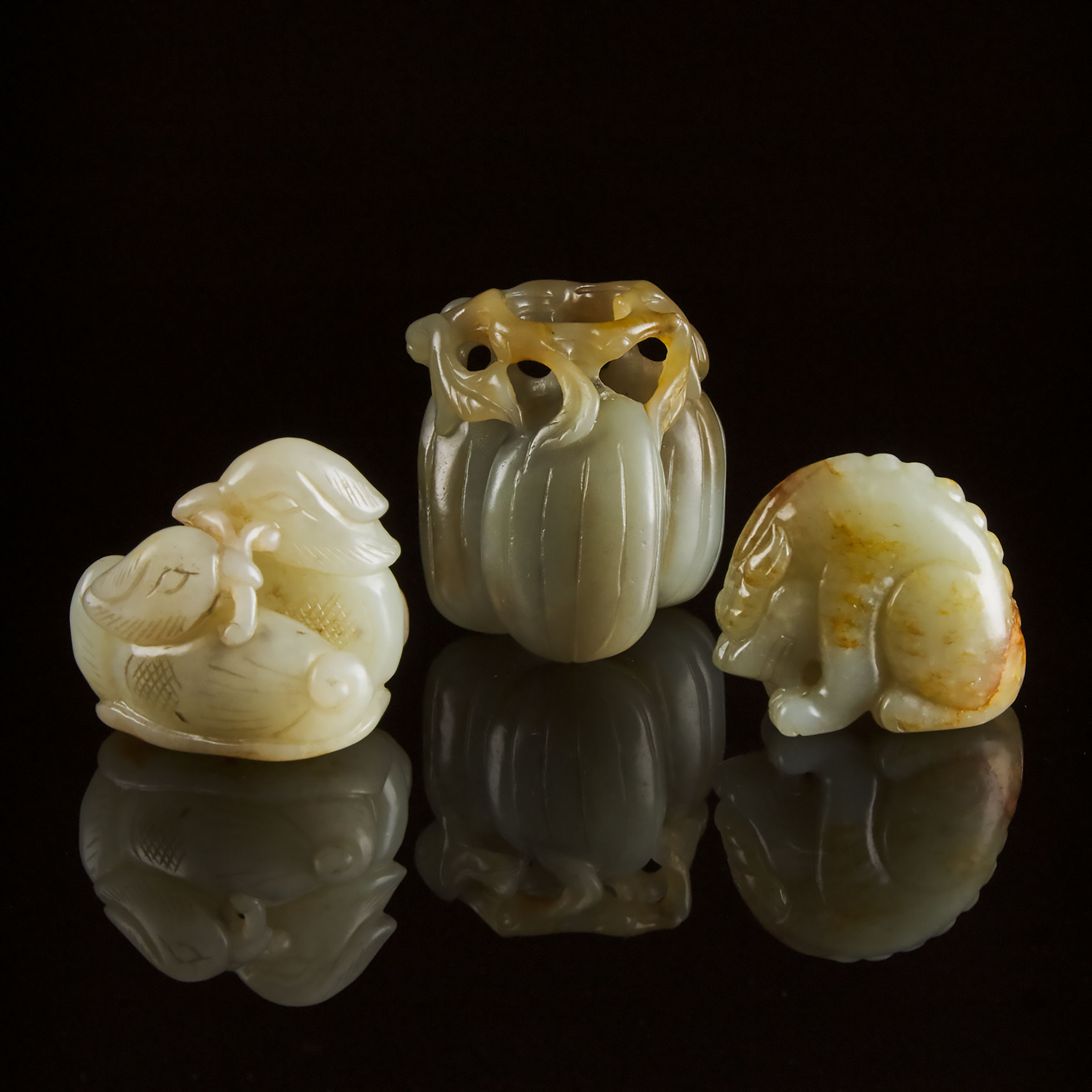 A Group of Three White and Celadon Jade Carvings