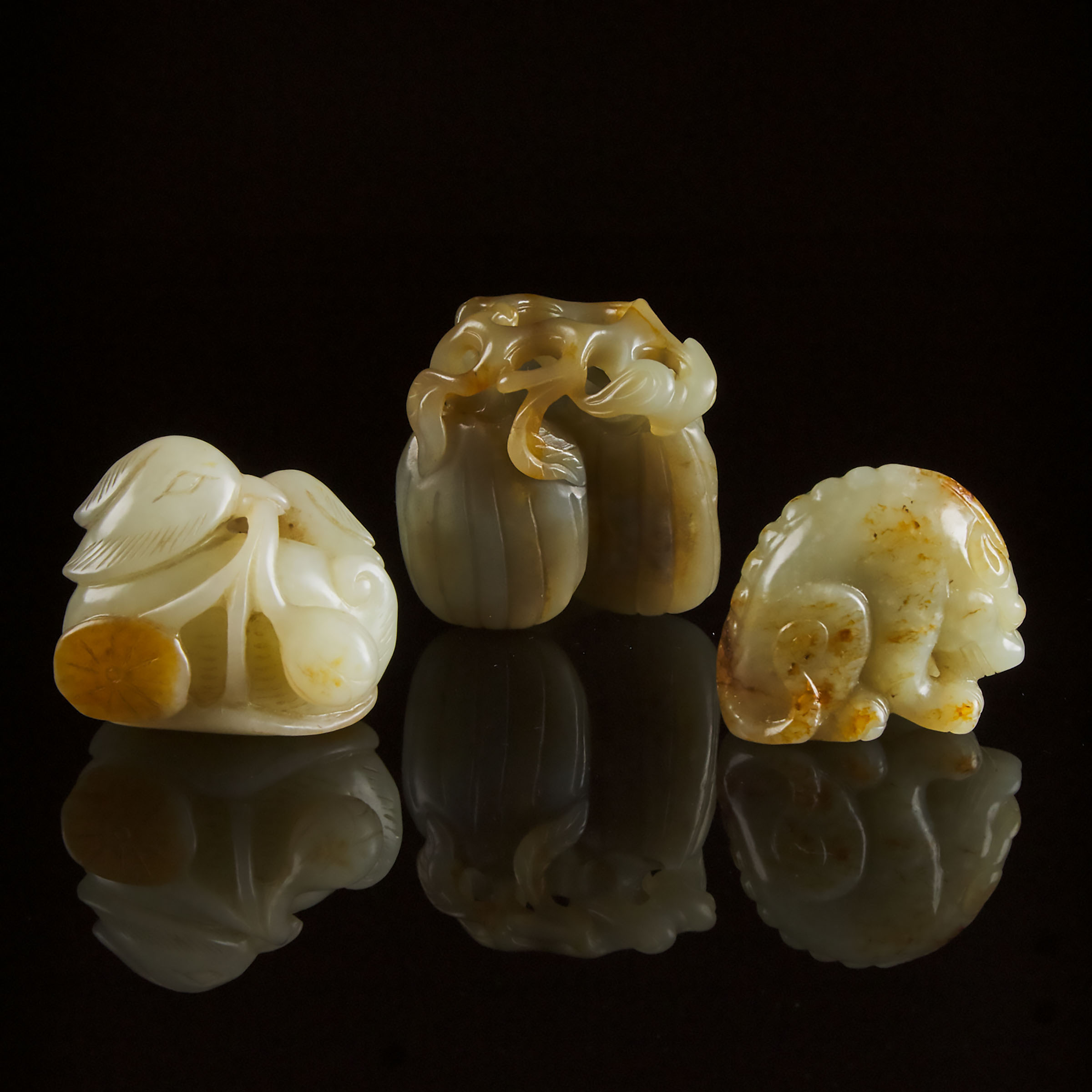 A Group of Three White and Celadon Jade Carvings